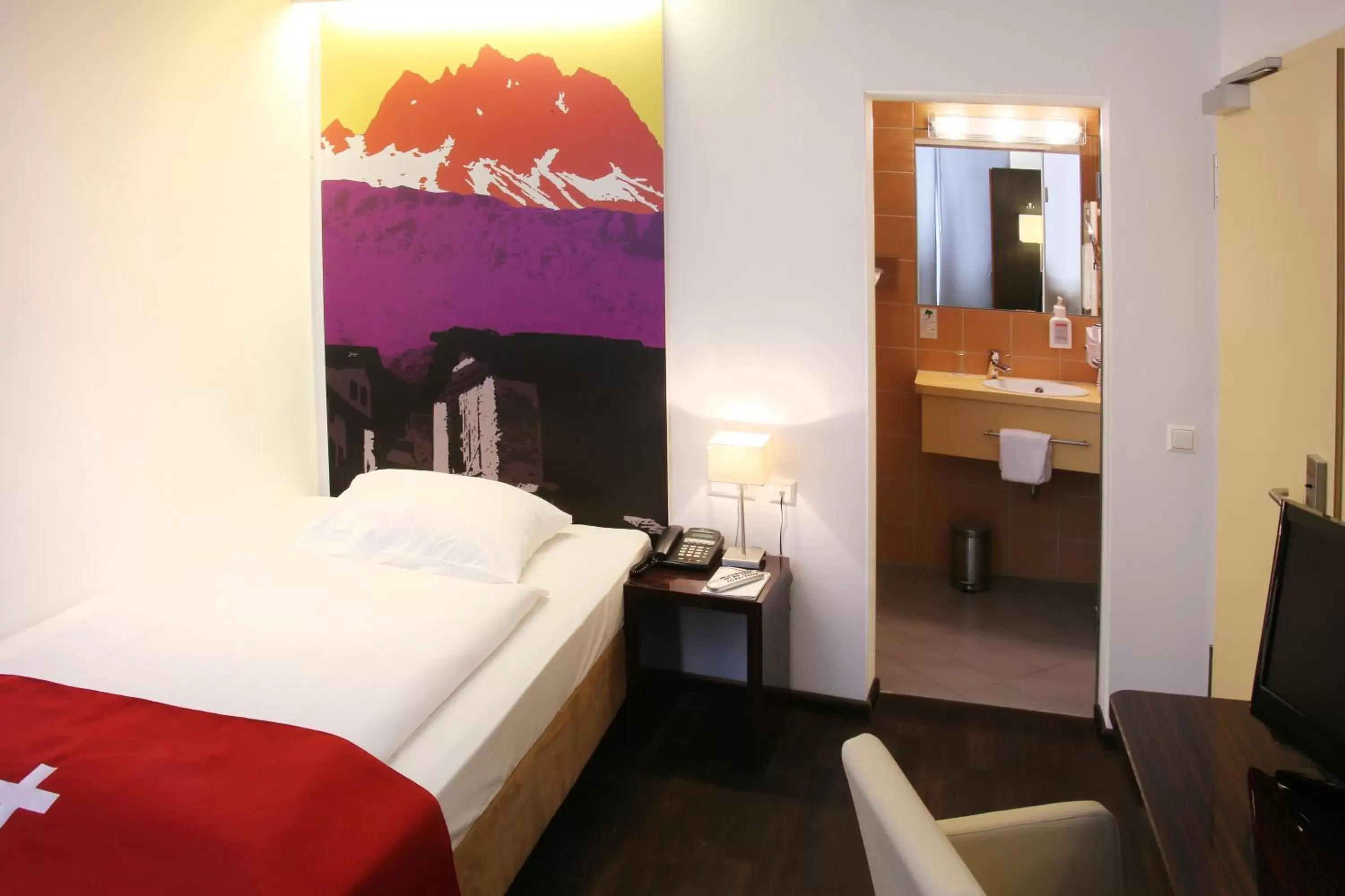 Bedroom, Bed in Helvetia Hotel Munich City Center