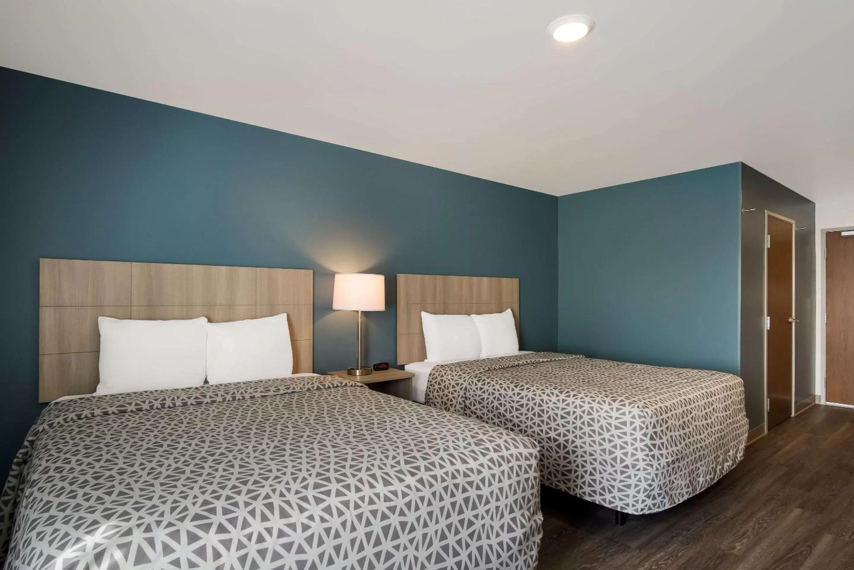 Bedroom, Bed in WoodSpring Suites Grand Rapids Kentwood