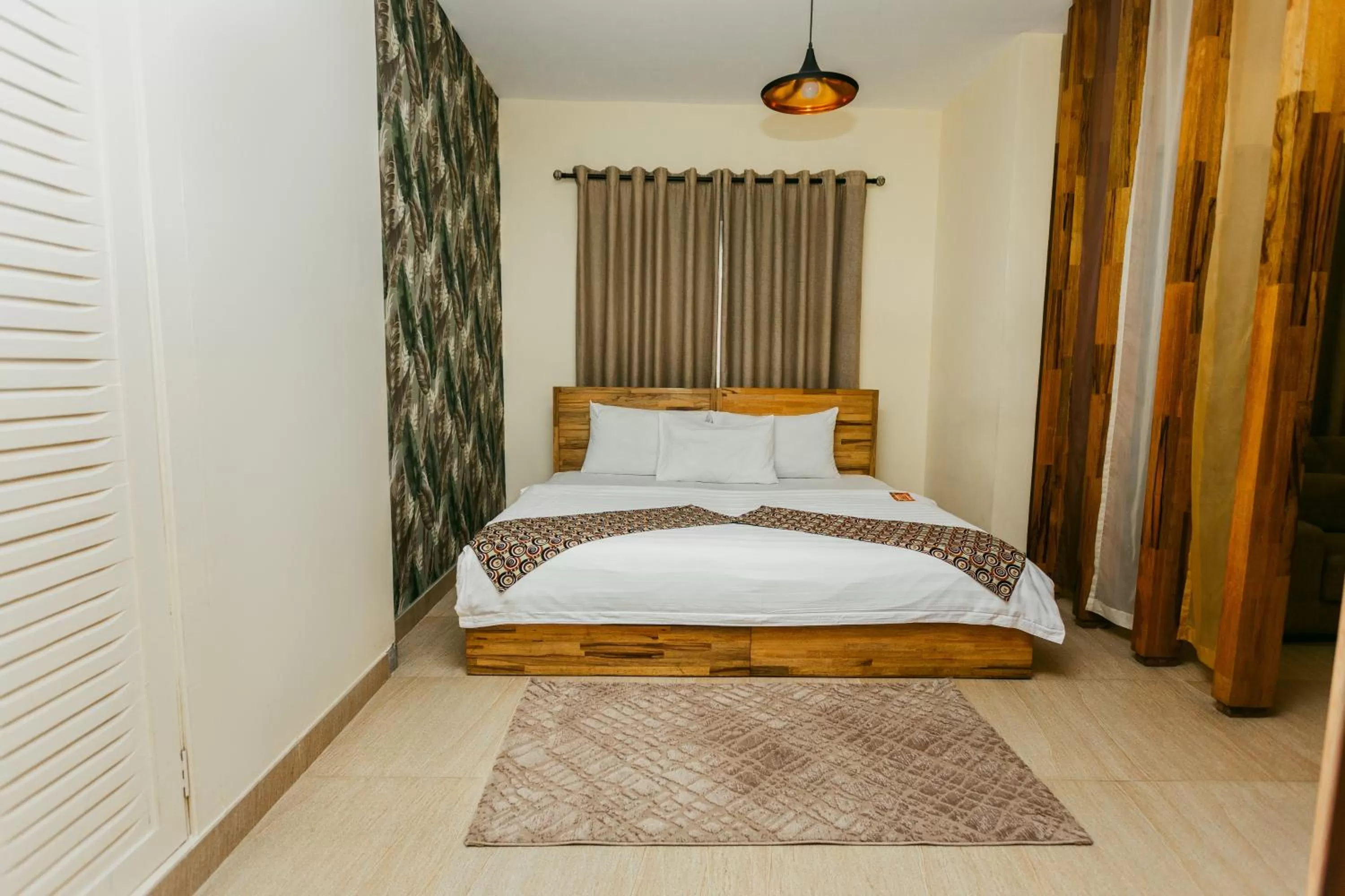 Bed in Roots Hotel Apartment