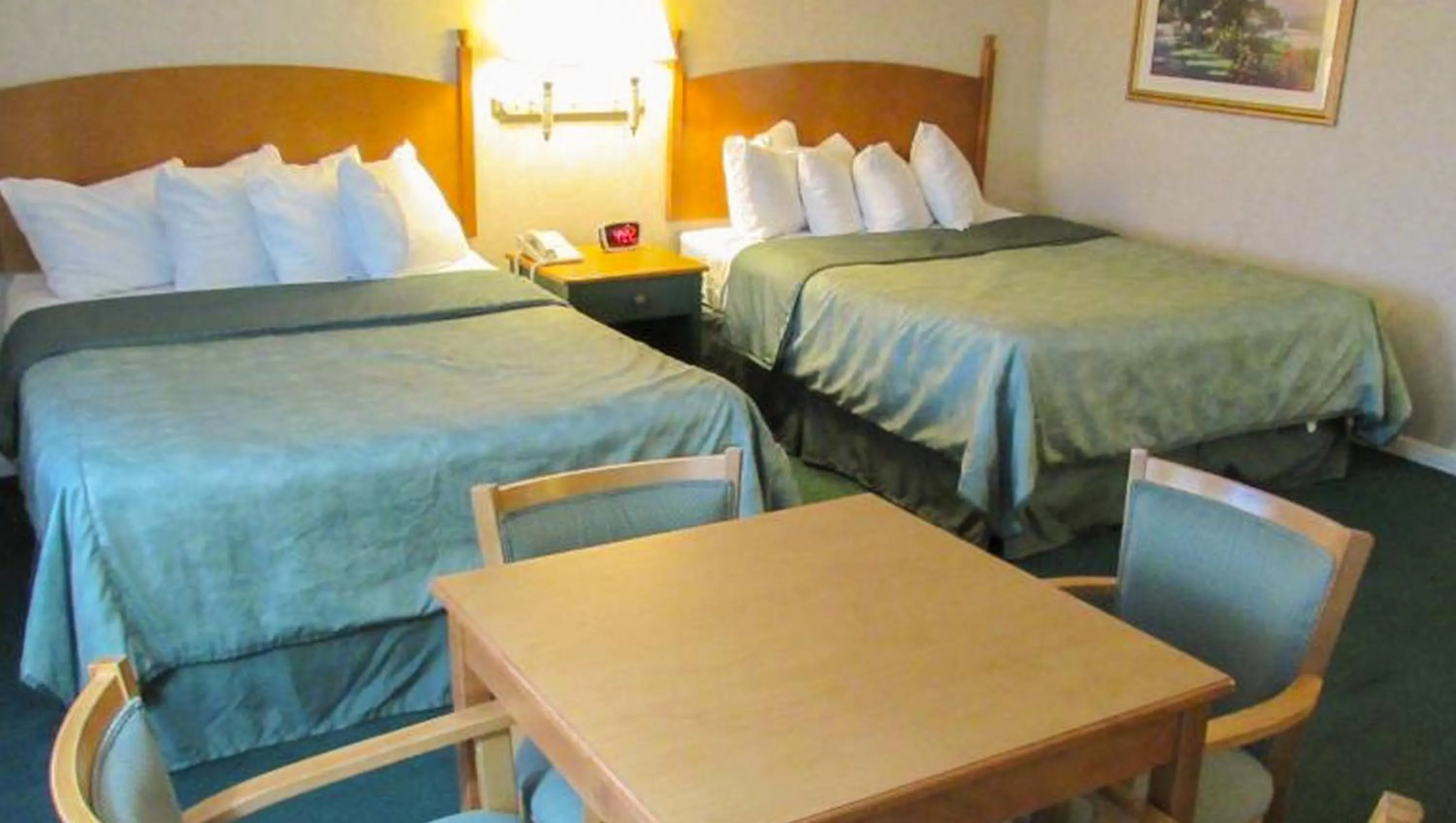 Queen Room with Two Queen Beds with Sofa in Magnuson Grand Pioneer Inn And Suites