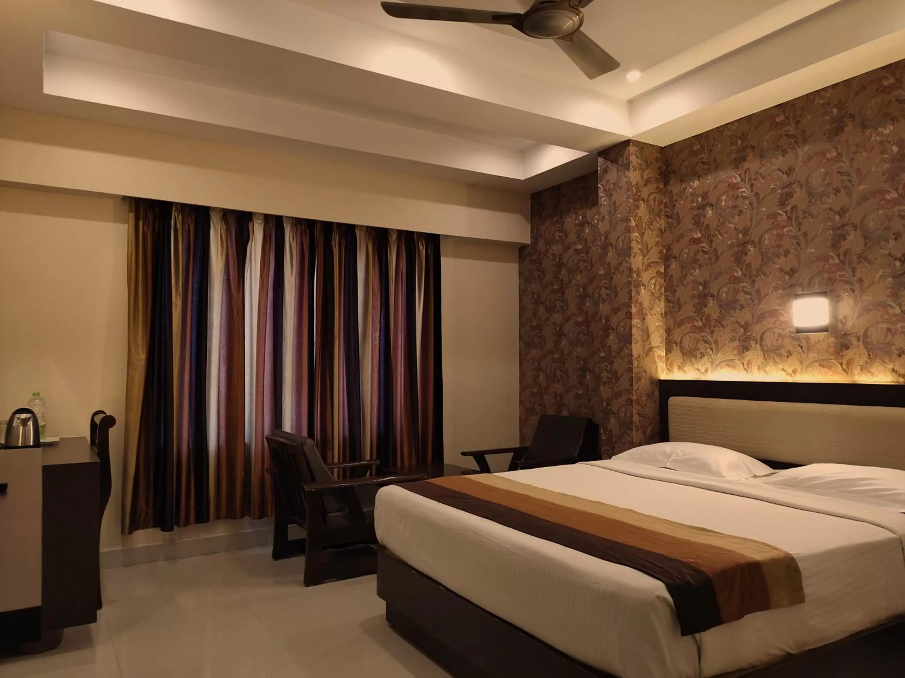 Seating area, Bed in Hotel Deepam