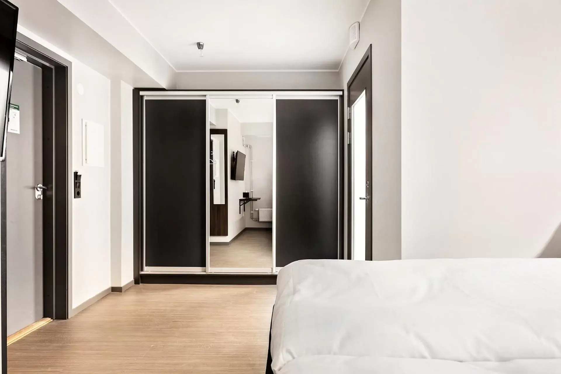 wardrobe, Bed in Sure Hotel Studio by Best Western Bromma