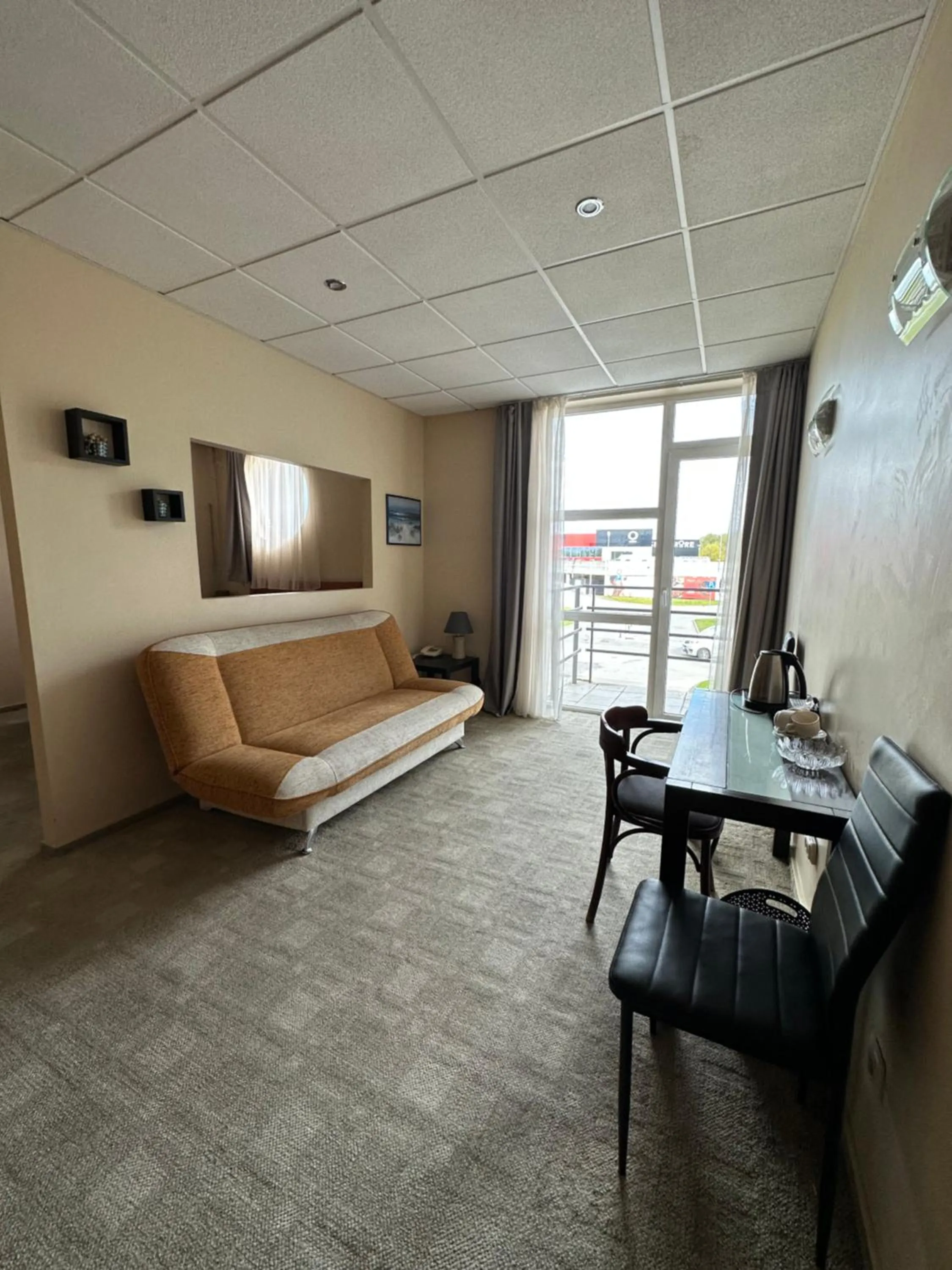 Communal lounge/ TV room, Bed in Riga Unimars Hotel