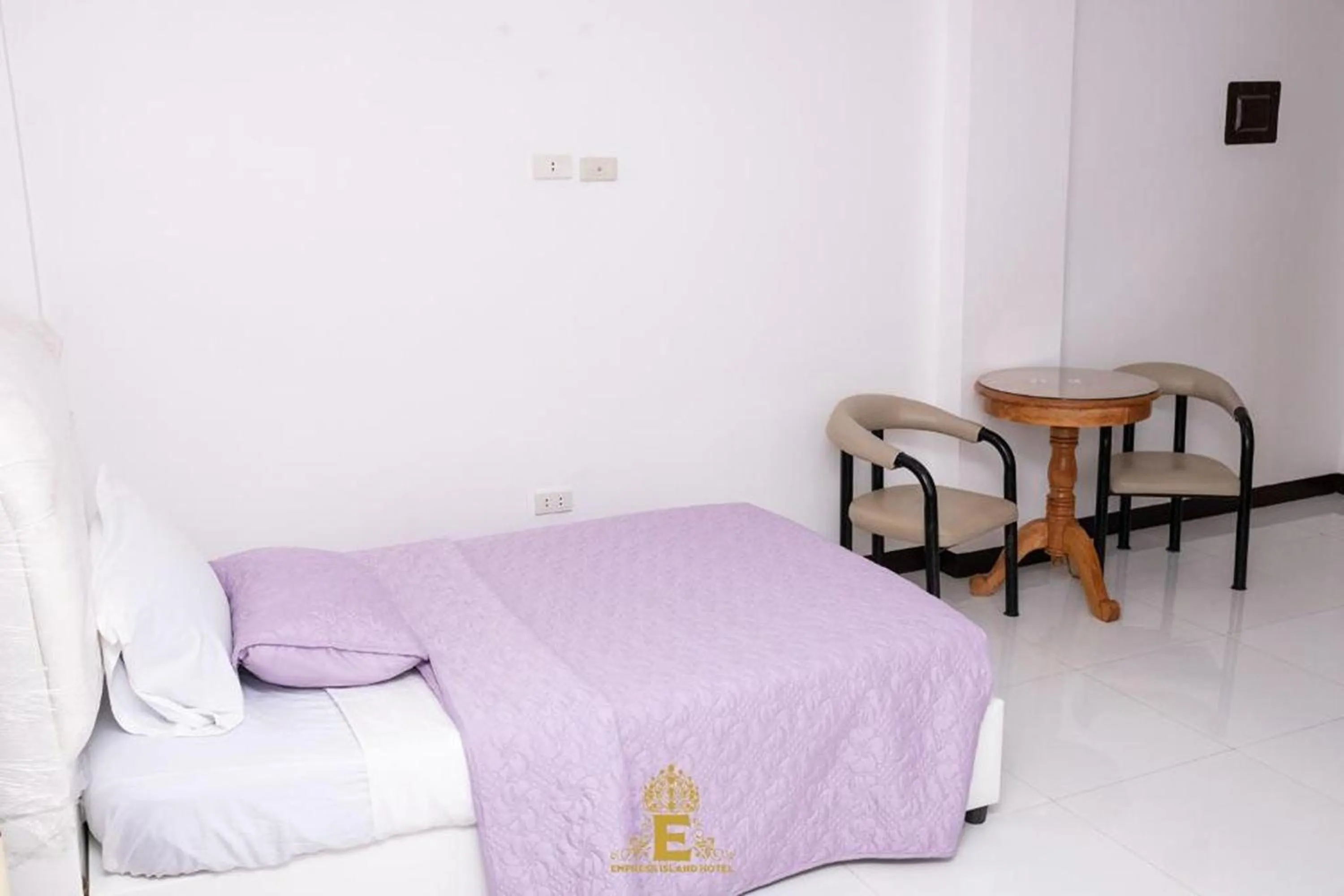 Bed in Empress Island Hotel