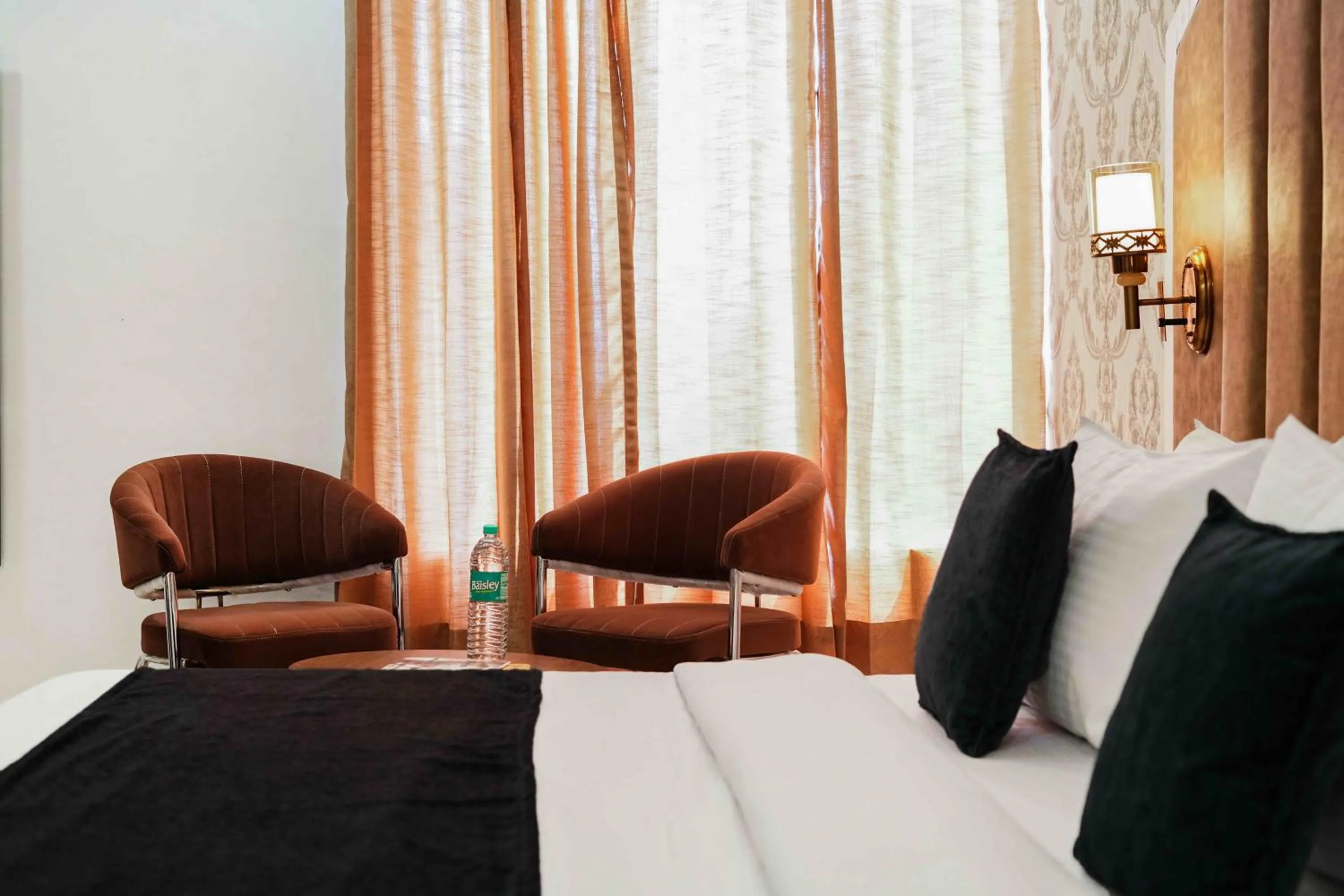 Seating area, Bed in Hotel Paras Chandigarh Zirakpur