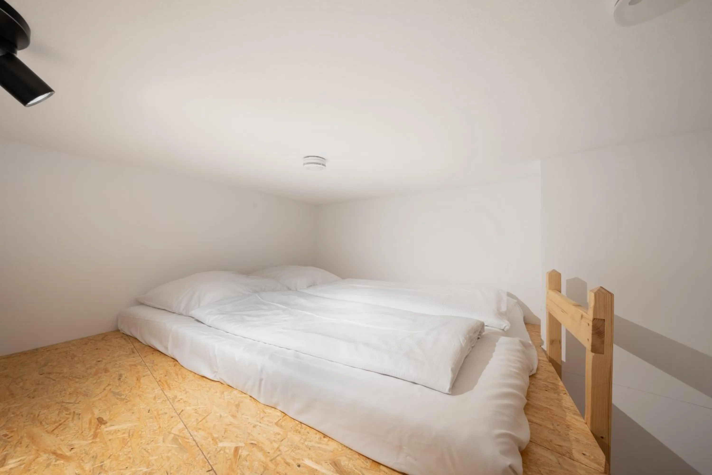 Bed in Servus Apartments by Homaris