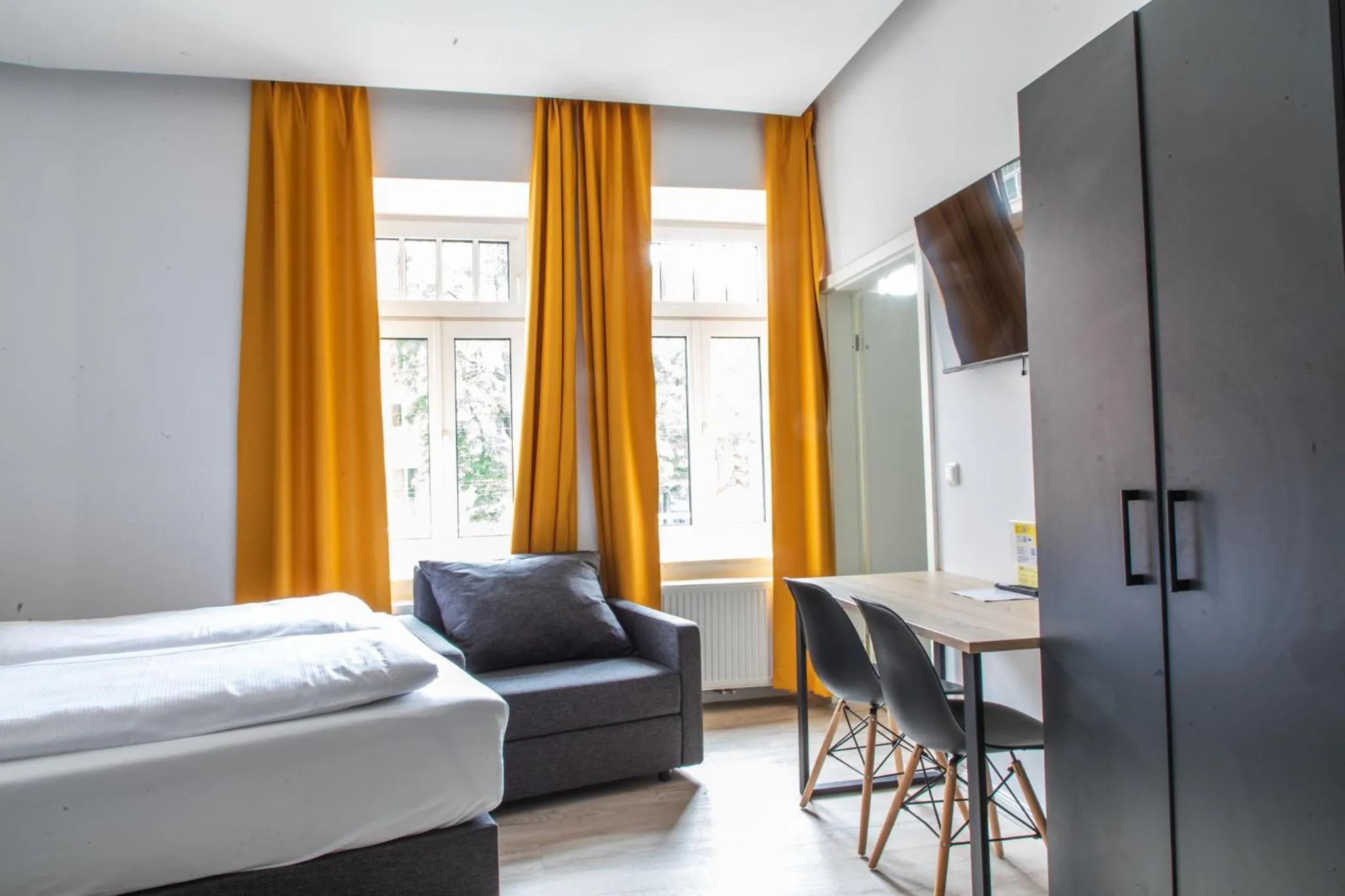 Bed in Servus Apartments by Homaris
