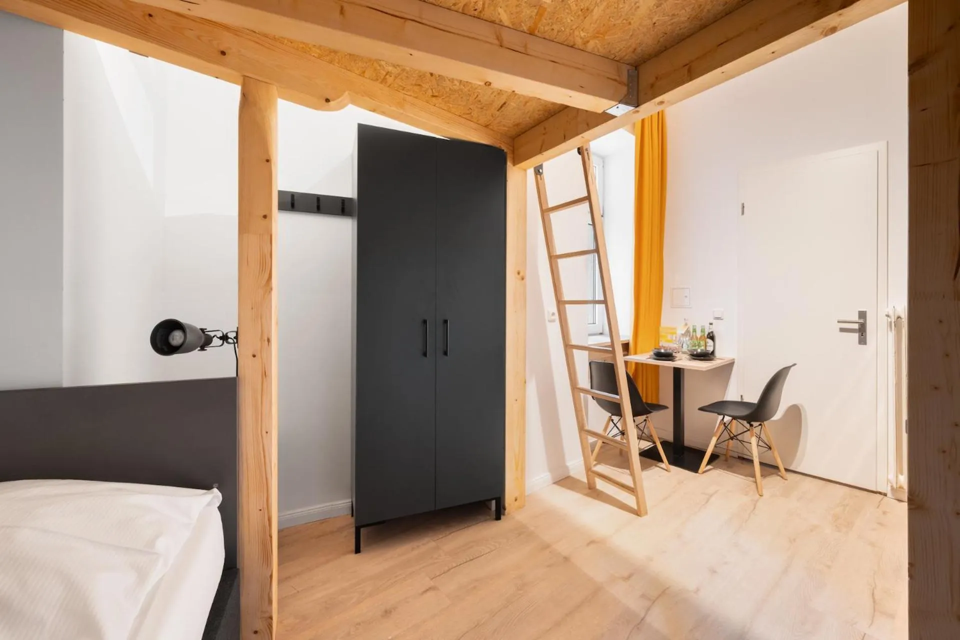 Bed in Servus Apartments by Homaris