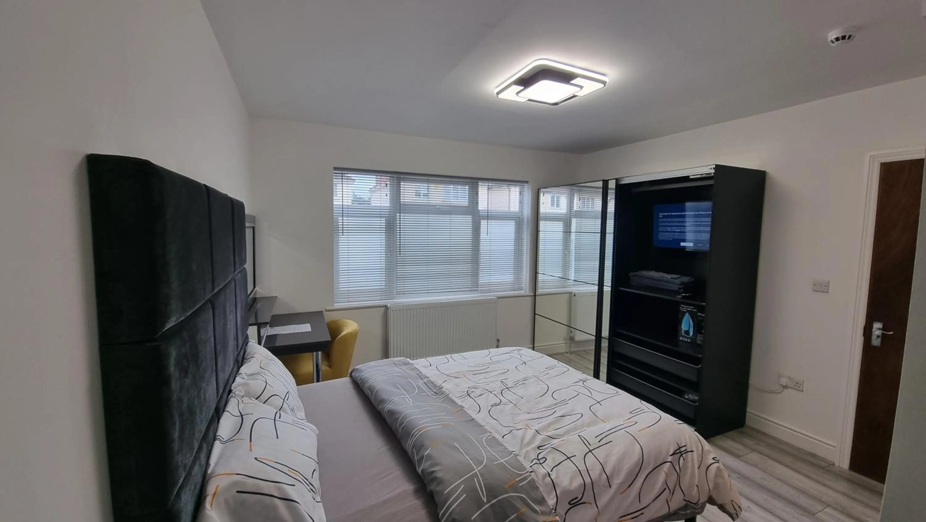 Bed in Stylish Suites with kitchenette