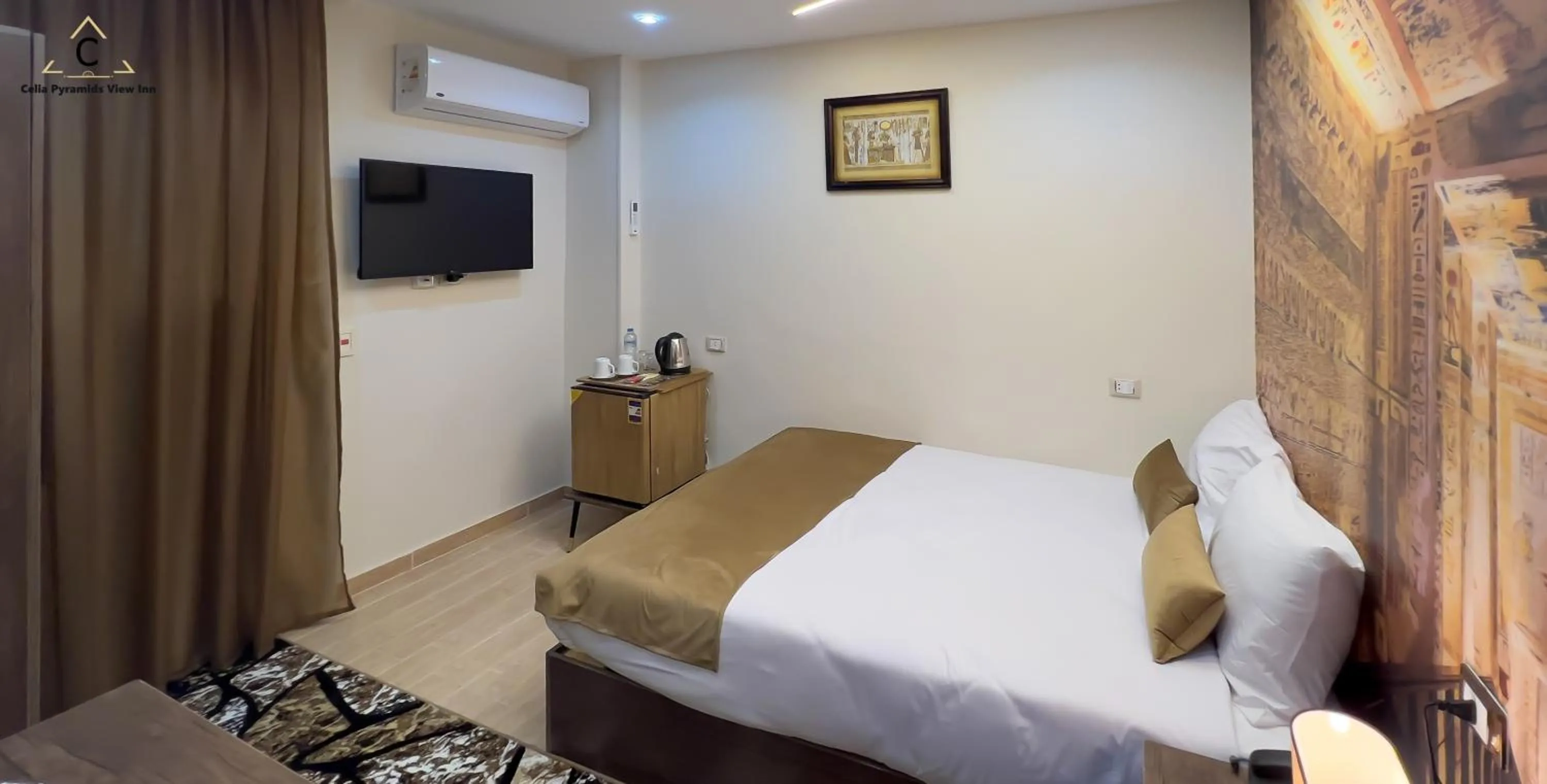 Bed in Celia Pyramids View inn