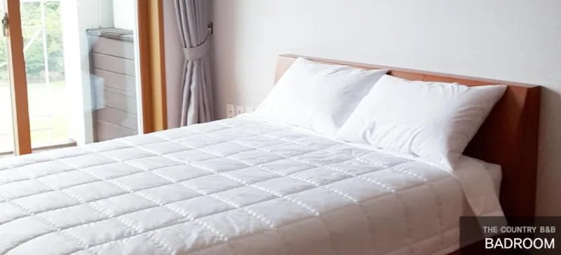 Bed in Jeju Land Pension