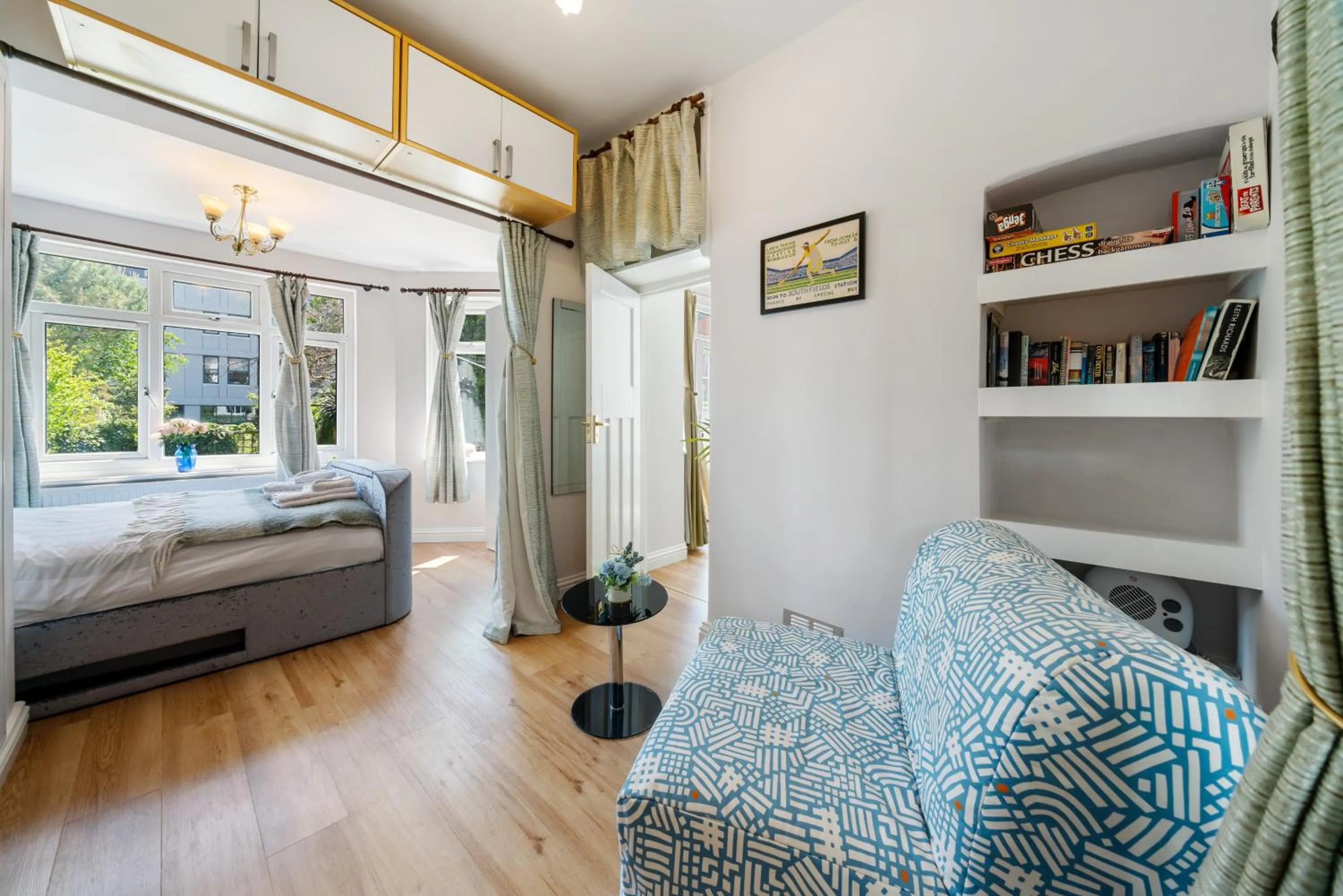 Seating area, Bed in Lovely garden apartment in Wimbledon Town Centre with private parking by Wimbledon Holiday Lets