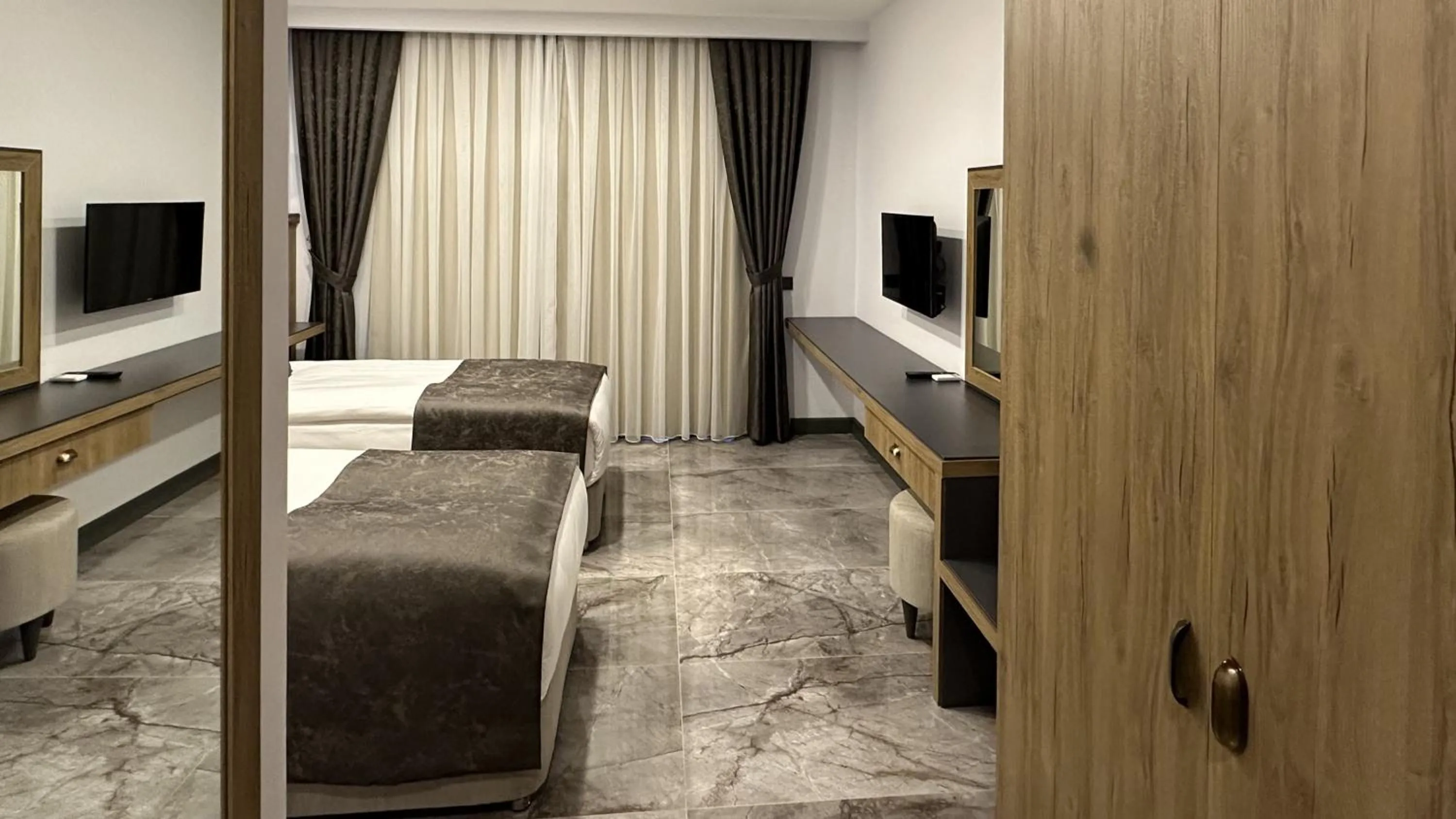 Bed in Quality Gold Suite Hotel