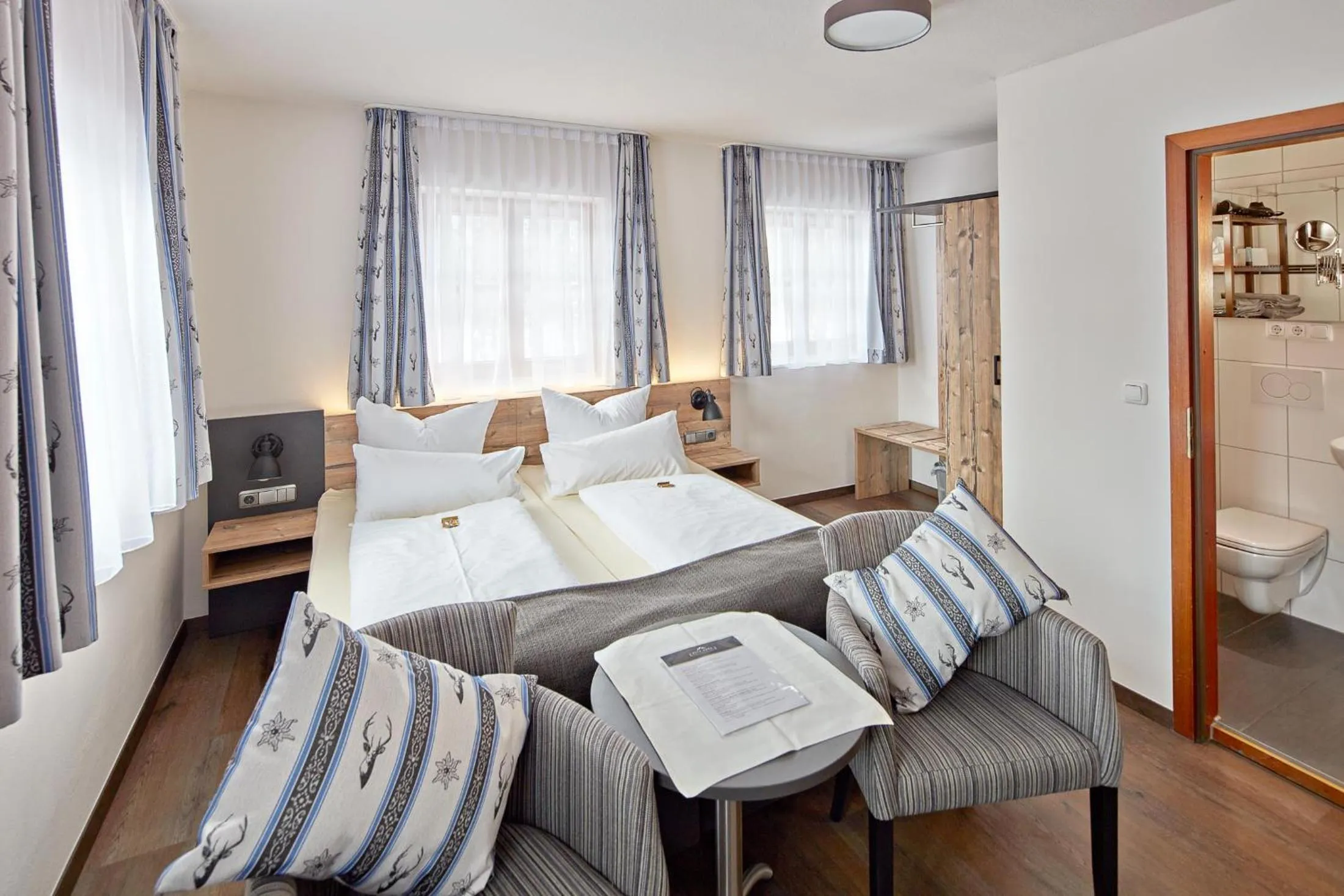 Photo of the whole room, Bed in Hotel Garni Alte Säge Ruhpolding inkl Chiemgaukarte