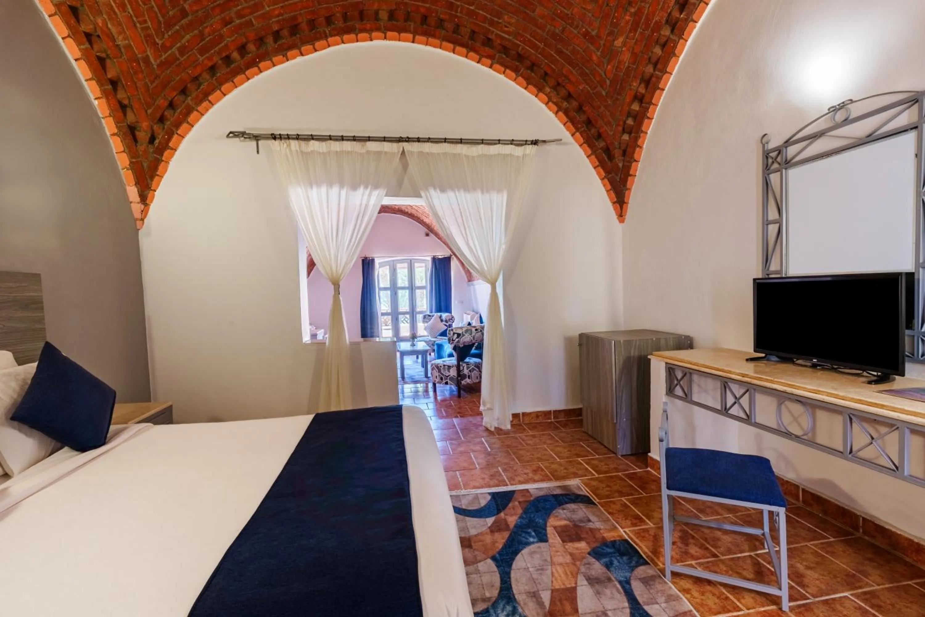 Seating area, Bed in Protels Crystal Beach Resort