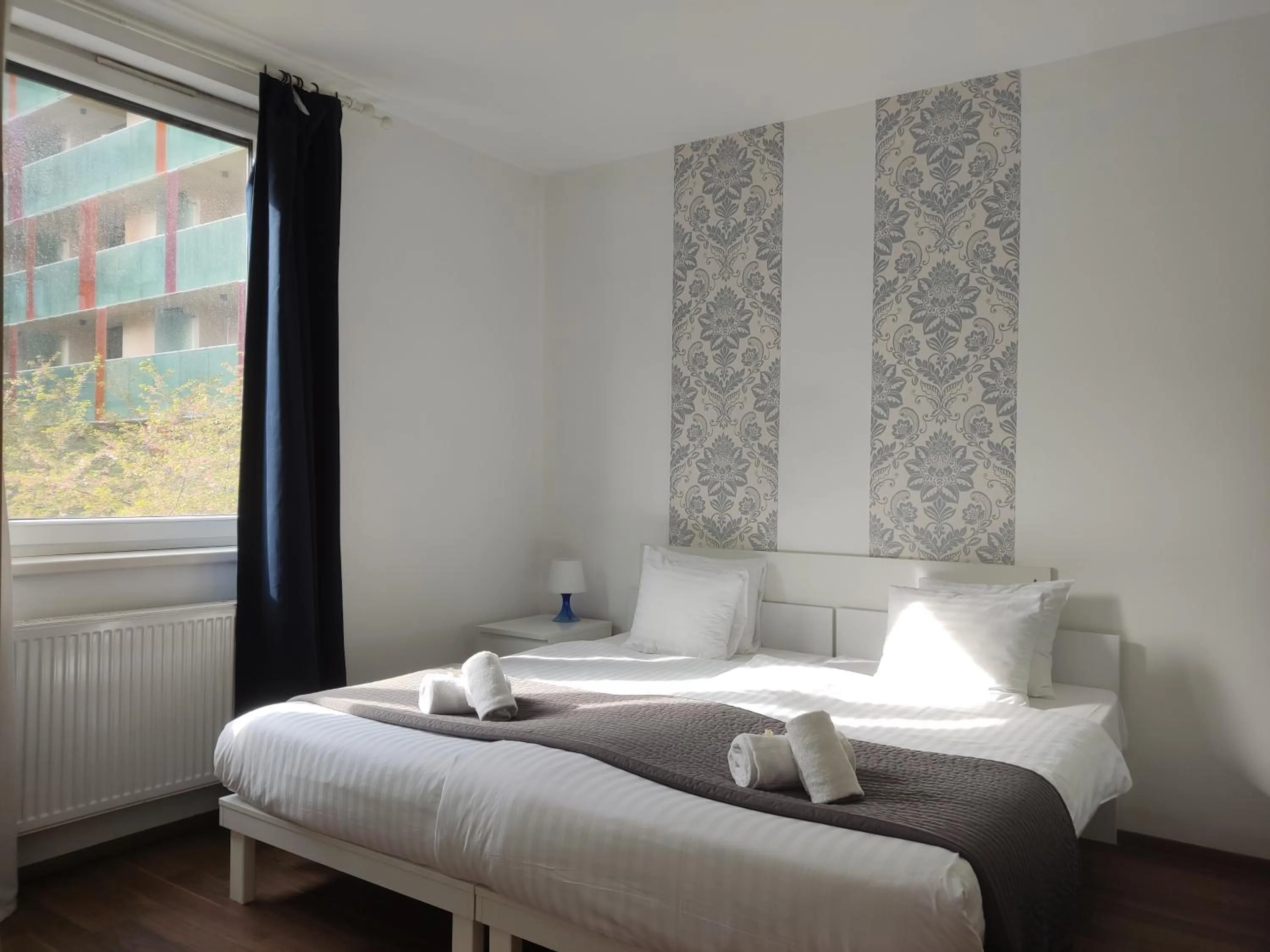 Bed in Corvin Center Suites