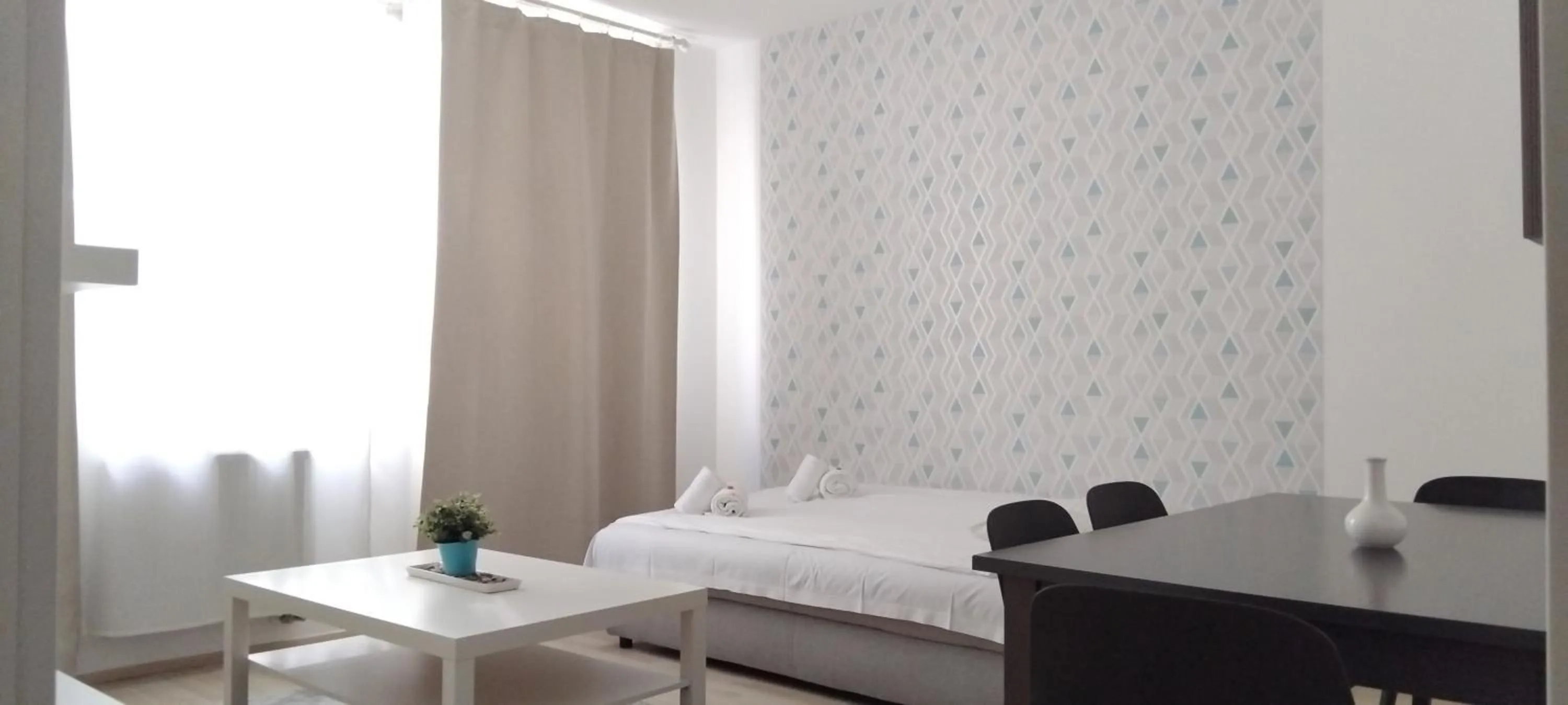 Bed in Corvin Center Suites