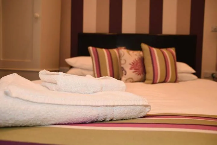 Bed in Harry's Hotel & Restaurant