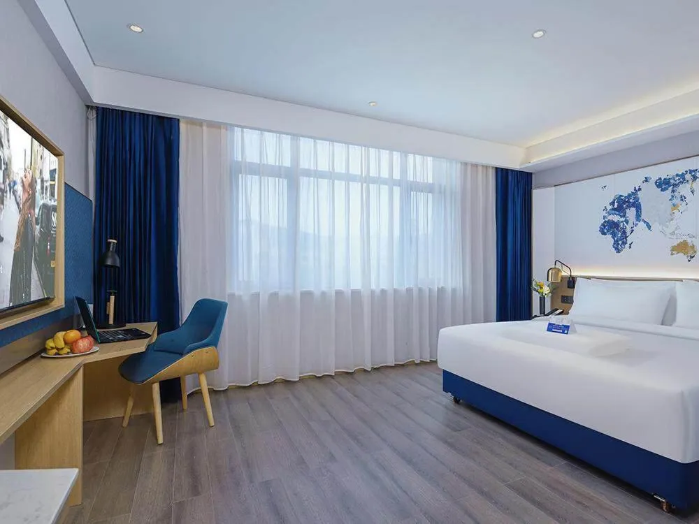 Bed in Kyriad Marvelous Hotel Weihai Happy Gate Weigao Plaza