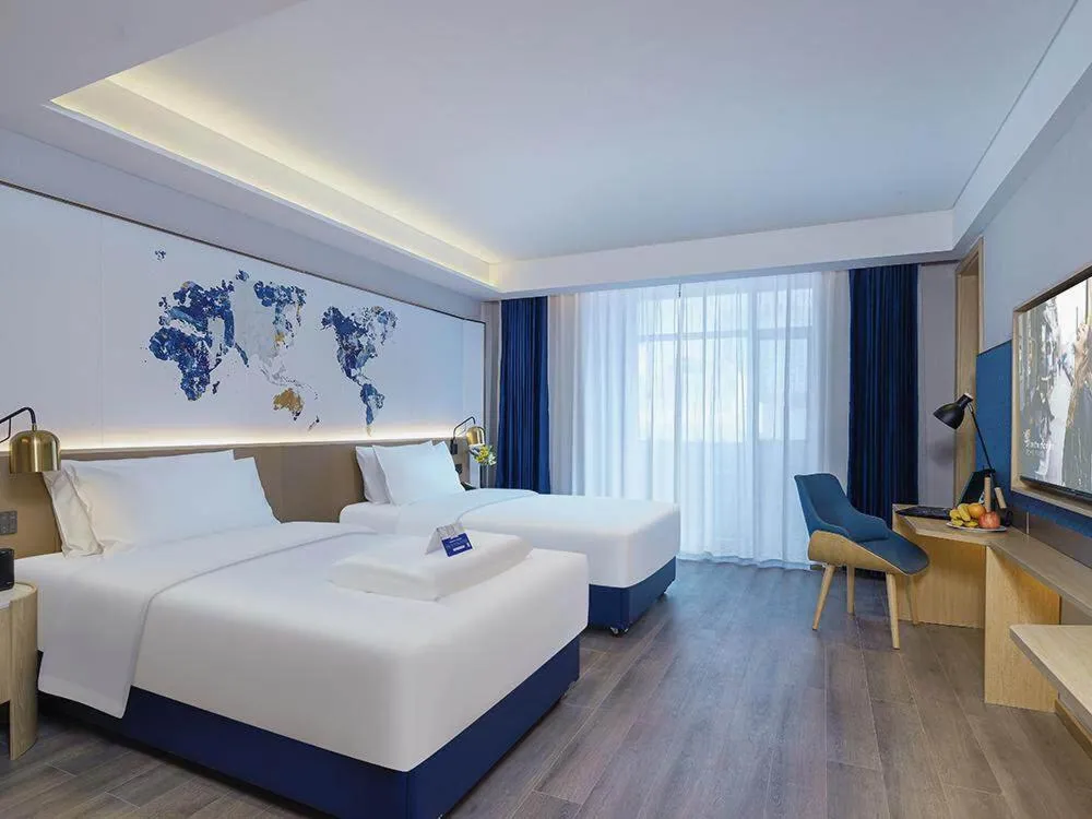 Bed in Kyriad Marvelous Hotel Weihai Happy Gate Weigao Plaza