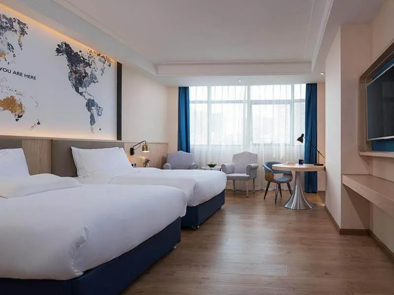 Bed in Kyriad Marvelous Hotel Heyuan Wanlong City