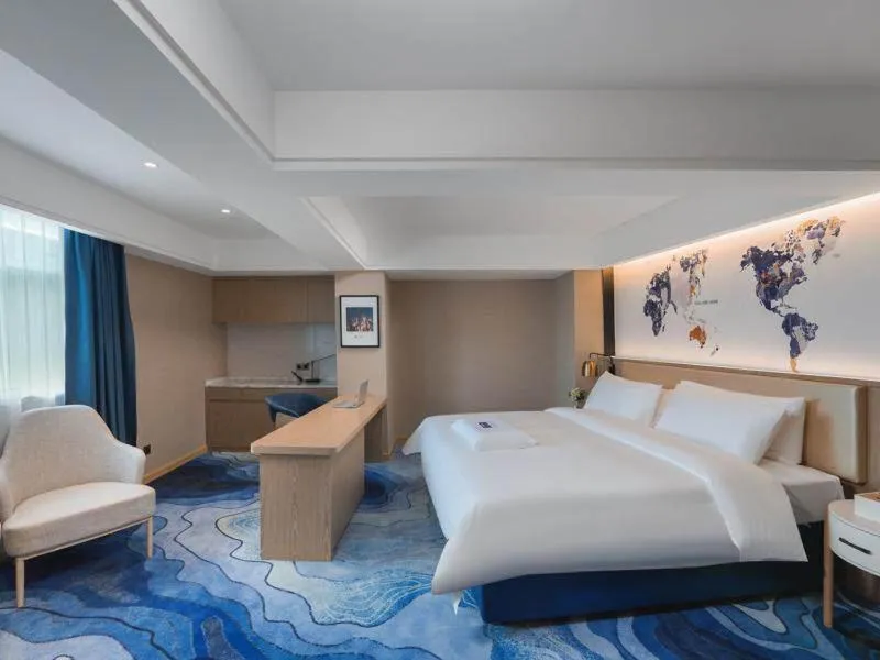 Bed in Kyriad Marvelous Hotel Shenzhen Guangming Zhenmei Subway Station