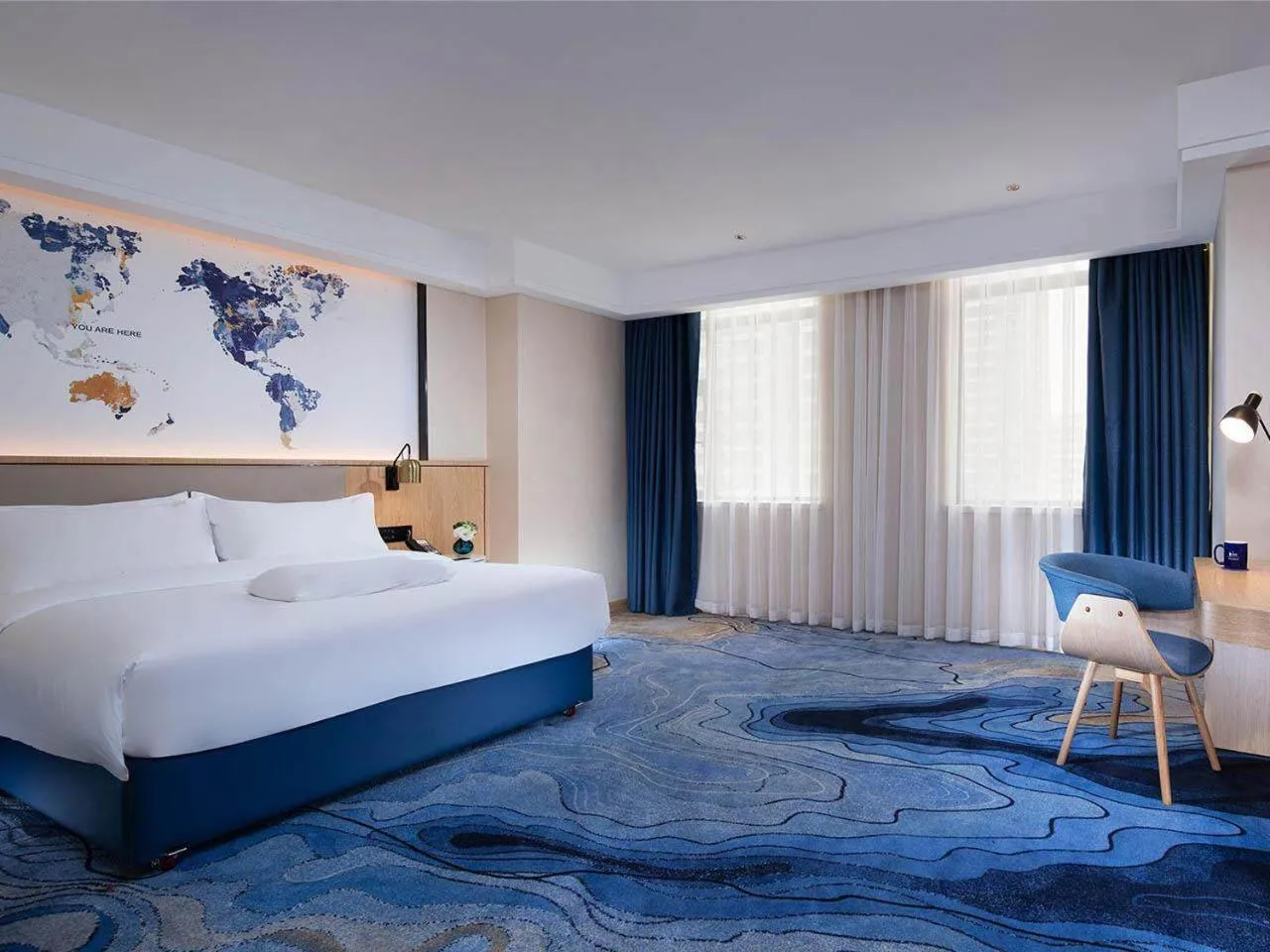 Bed in Kyriad Marvelous Hotel Maoming Dianbai Wanda Plaza