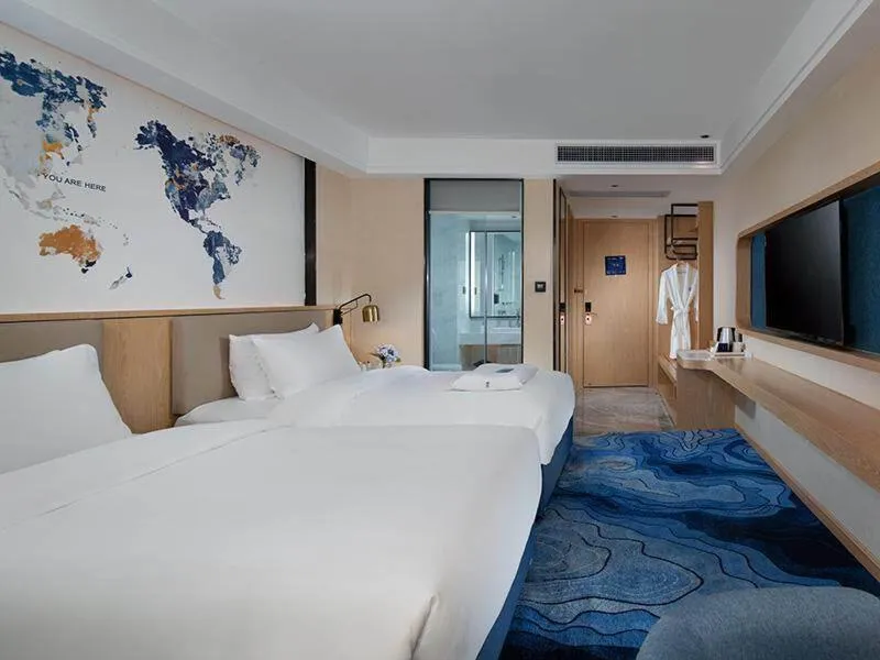 Bed in Kyriad Marvelous Hotel Maoming Dianbai Wanda Plaza