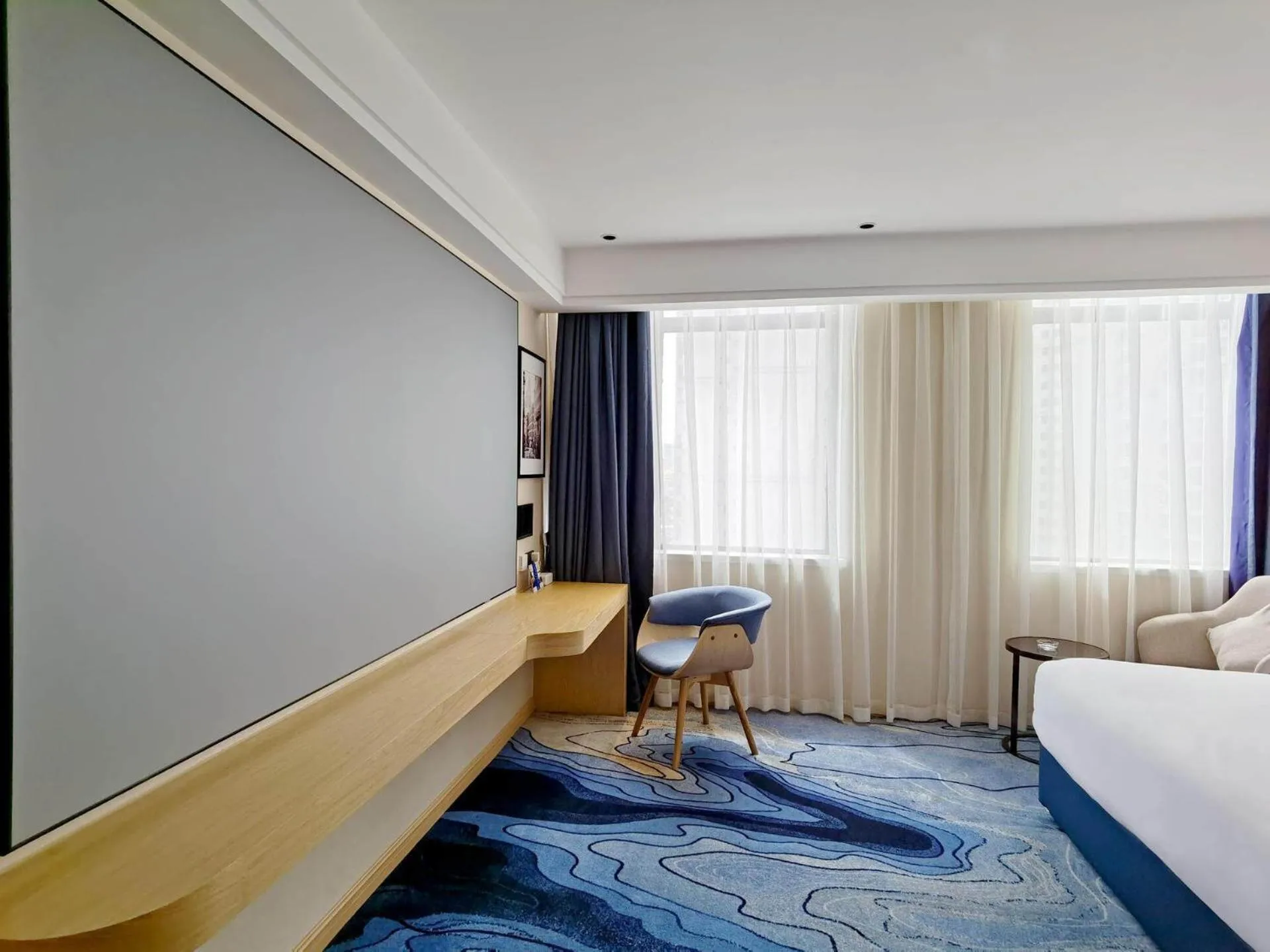 Bed in Kyriad Marvelous Hotel Maoming Dianbai Wanda Plaza