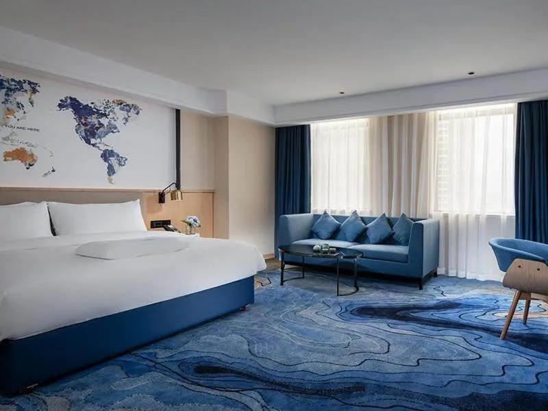Bed in Kyriad Marvelous Hotel Maoming Dianbai Wanda Plaza
