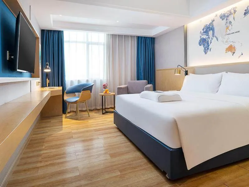 Bed in Kyriad Marvelous Hotel Dongguan Changan Light Rail Station
