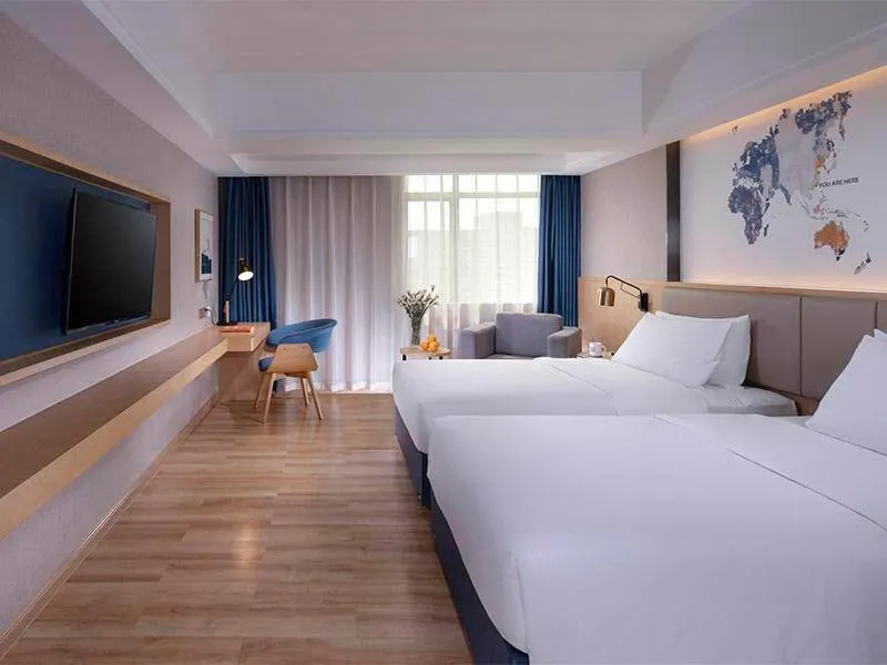 Bed in Kyriad Marvelous Hotel Dongguan Changan Light Rail Station