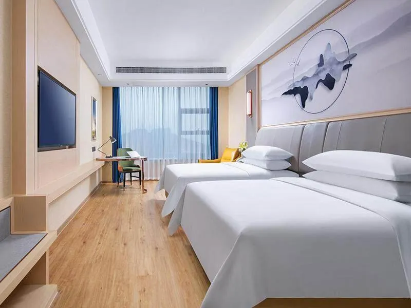 Bed in Vienna International Hotel Jiangsu Wuxi Jiangyin Sports Center