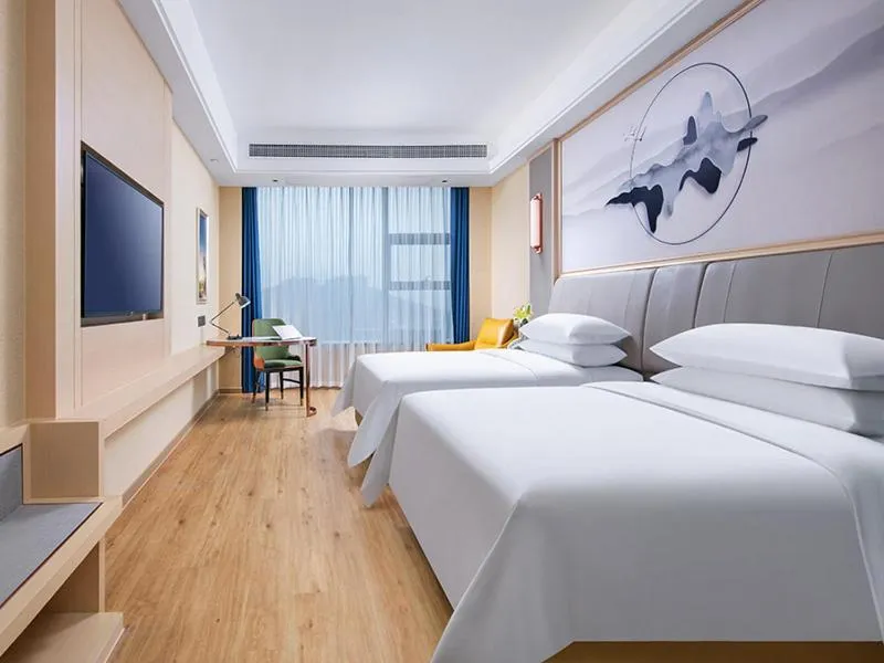 Bed in Vienna International Hotel Jiangsu Wuxi Jiangyin Sports Center