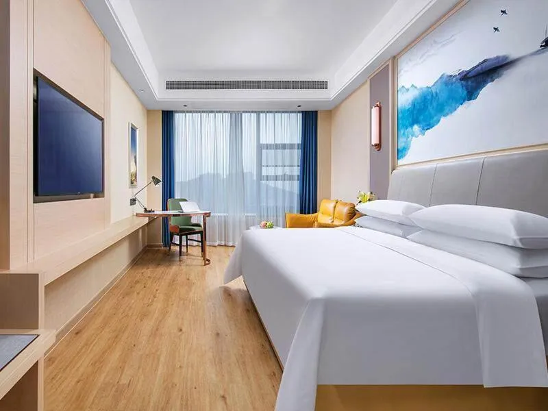 Bed in Vienna International Hotel Jiangsu Wuxi Jiangyin Sports Center