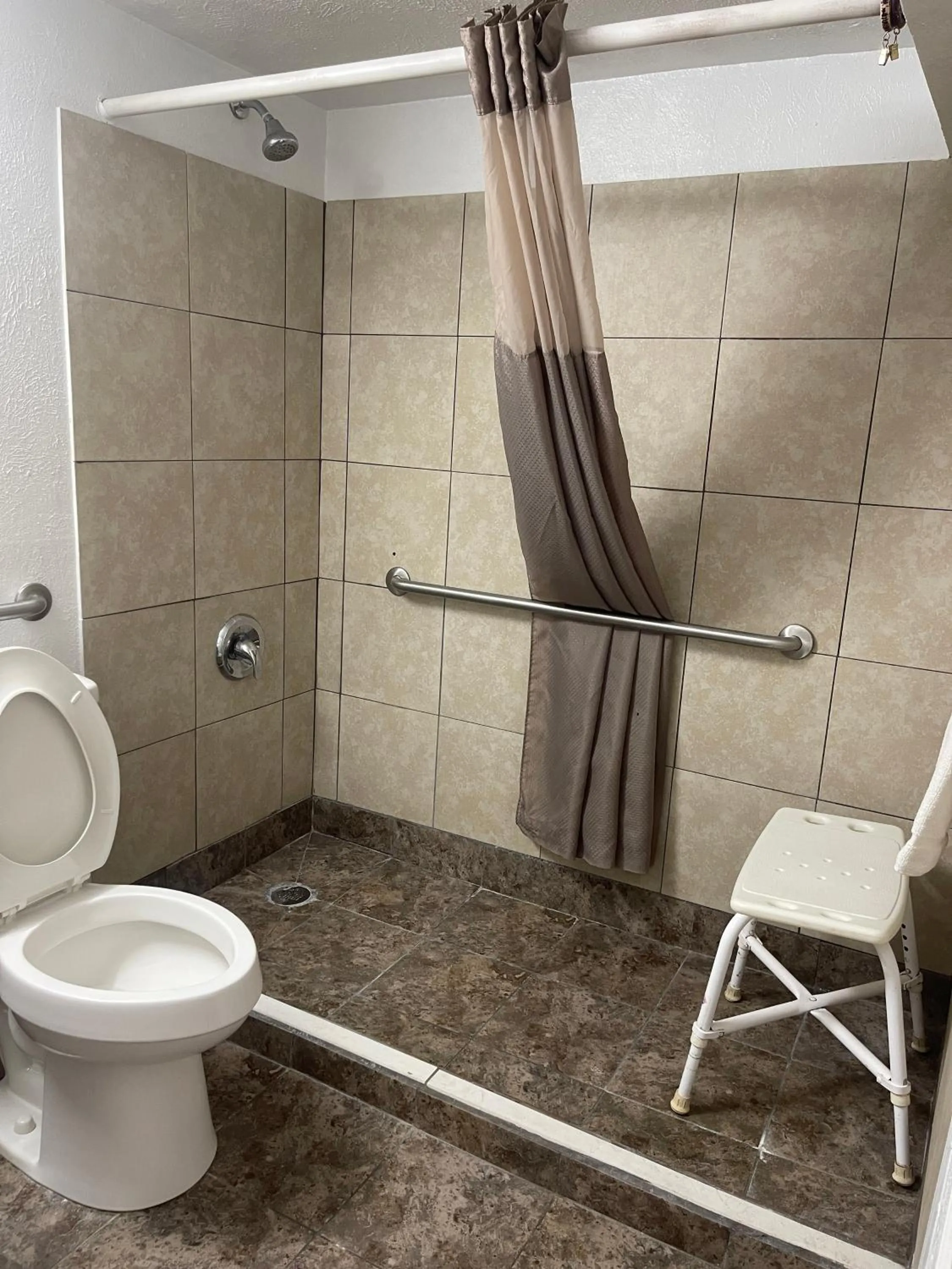 Shower in Regal 8 Inn & Suites
