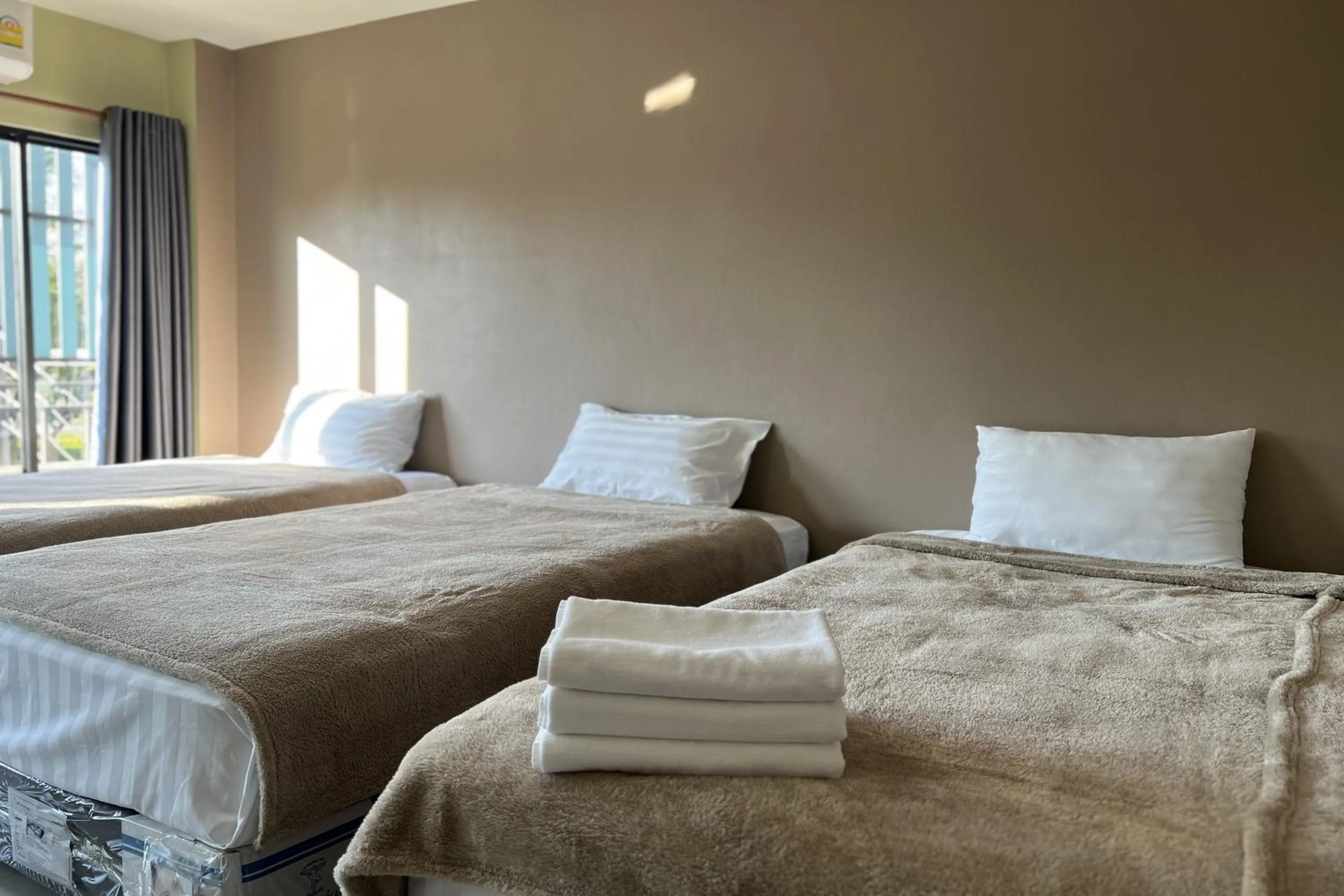 Bed in V Tharm Hotel