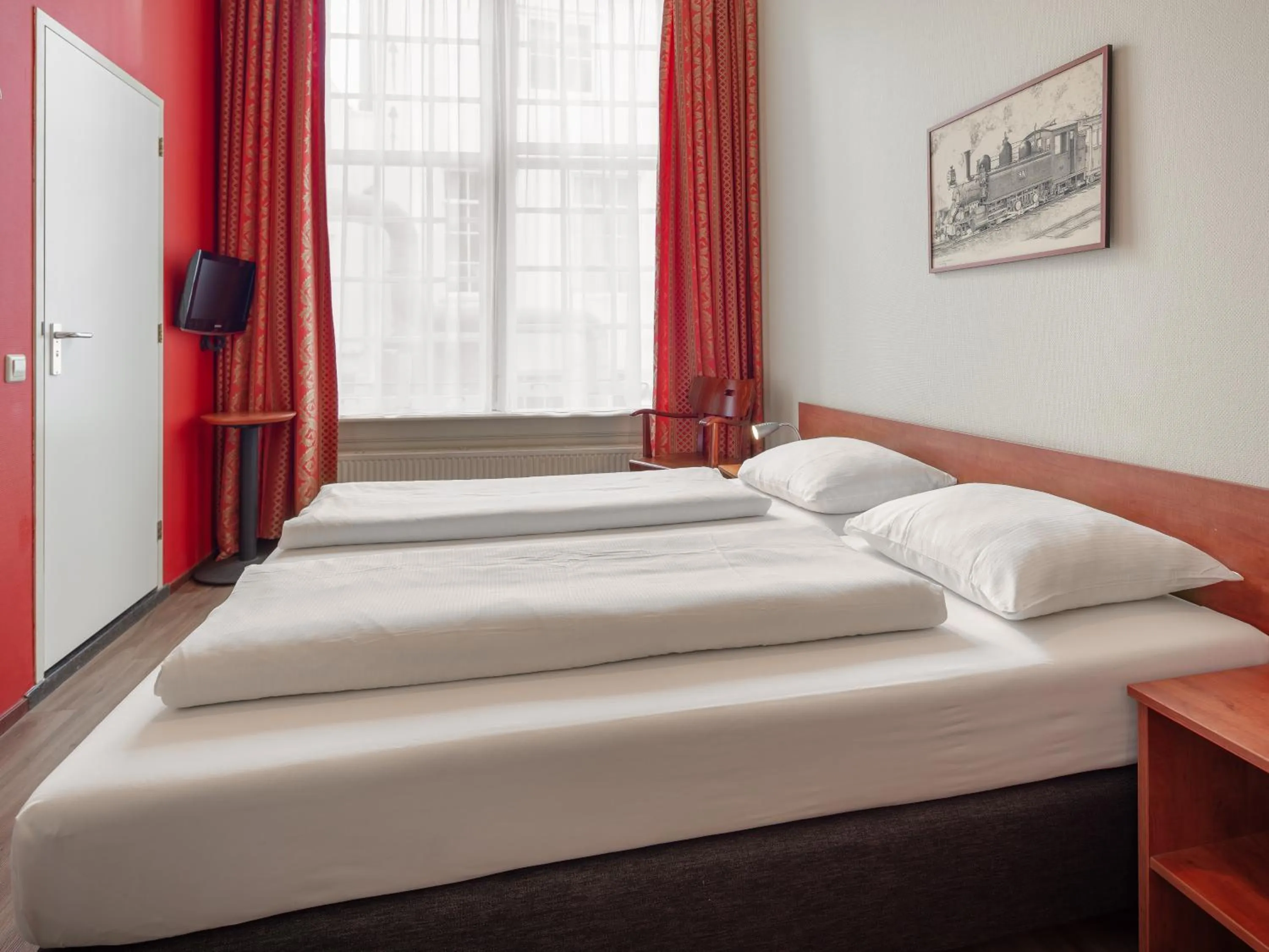 Bed in A-Train Hotel