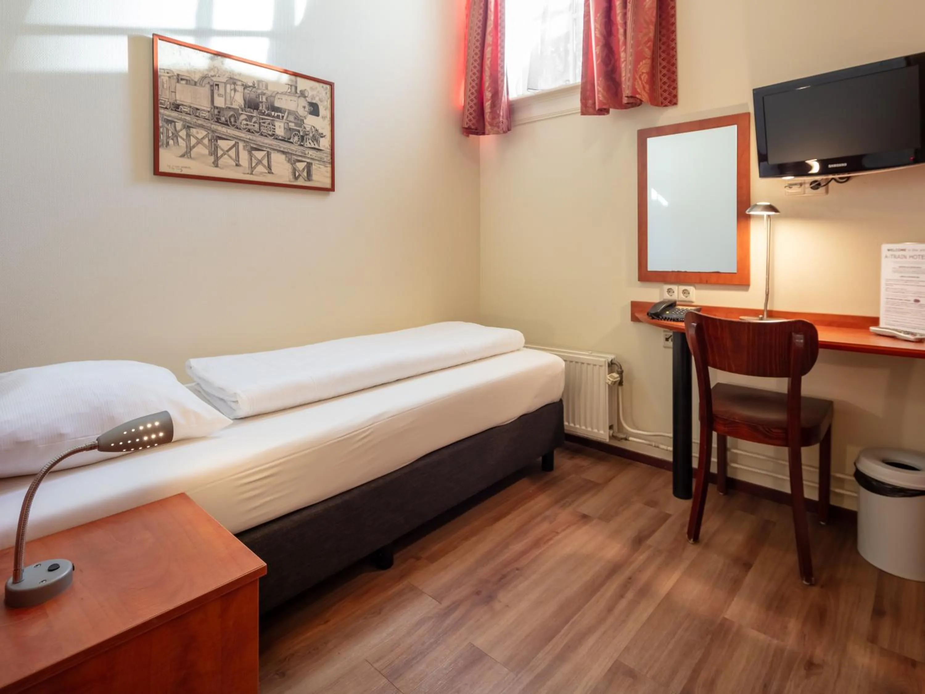 Bed in A-Train Hotel