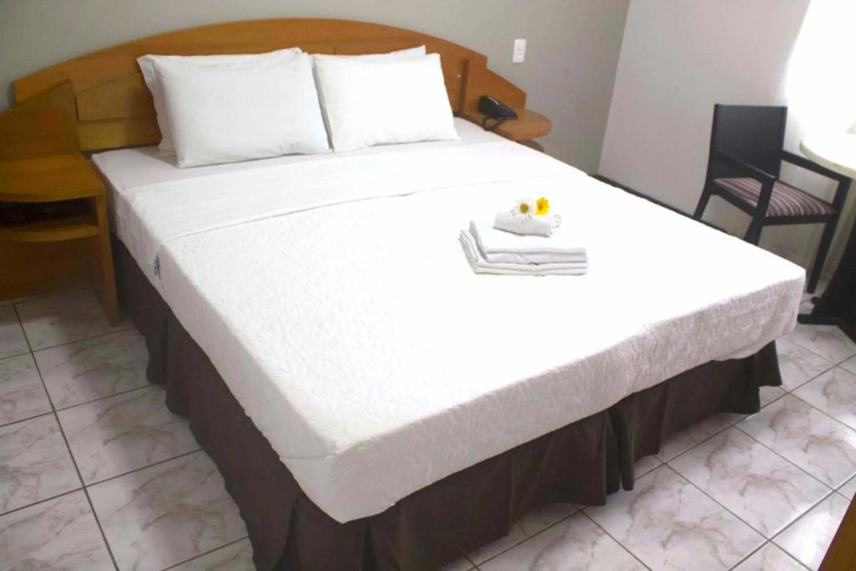 Bed in Flamboyant Hotel