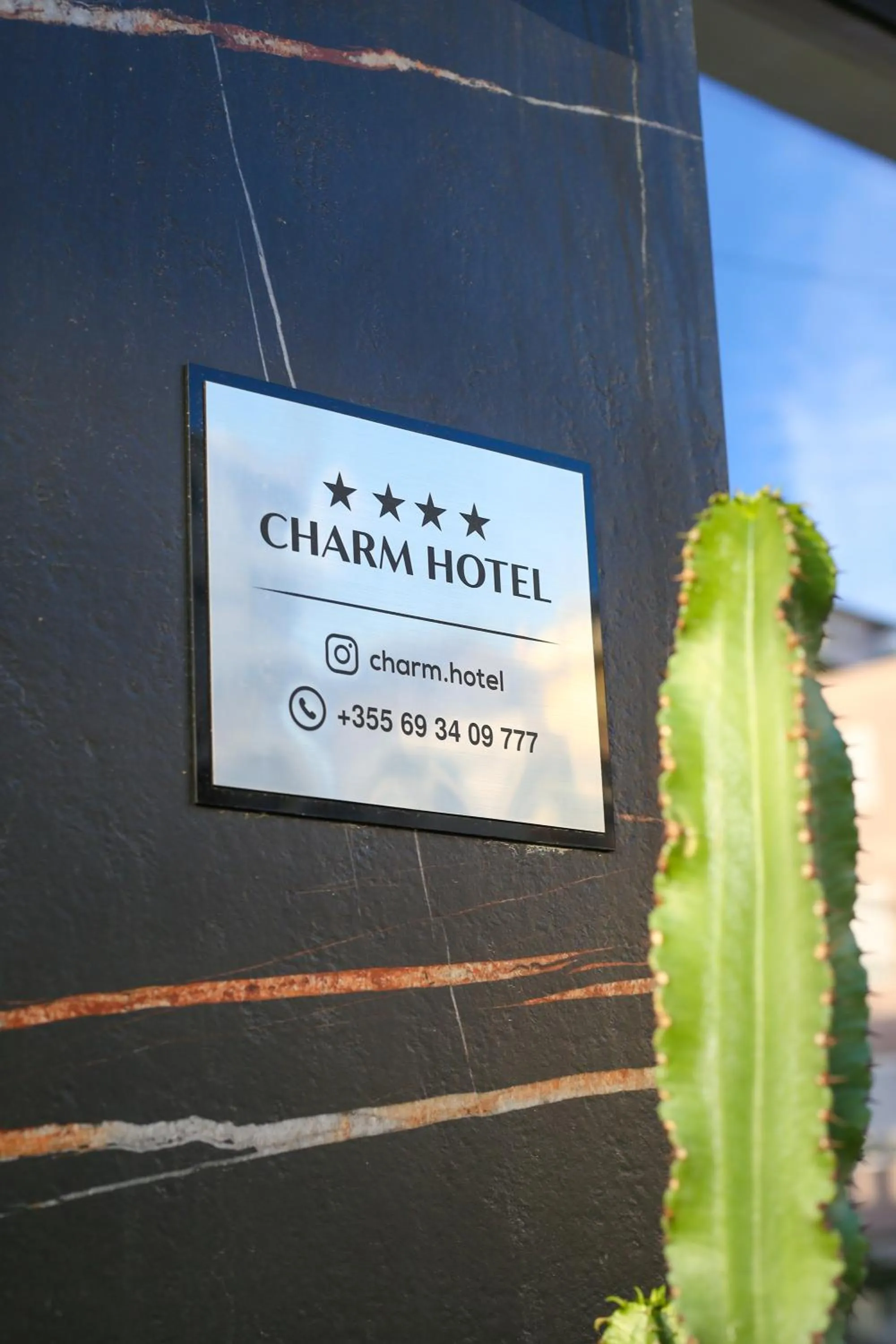 Property logo or sign in Charm Hotel