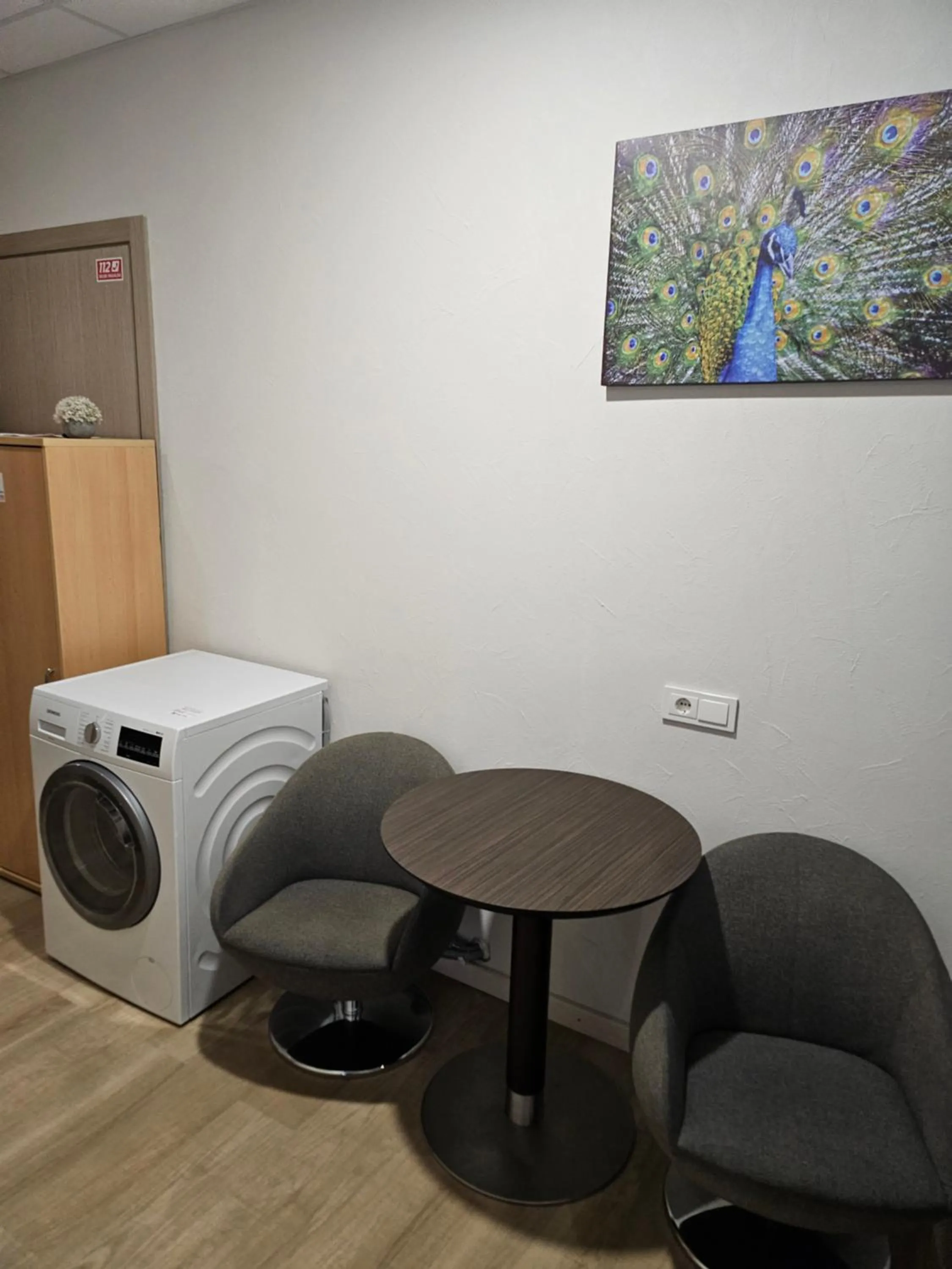 Seating area in Kauno apartamentai king size bed