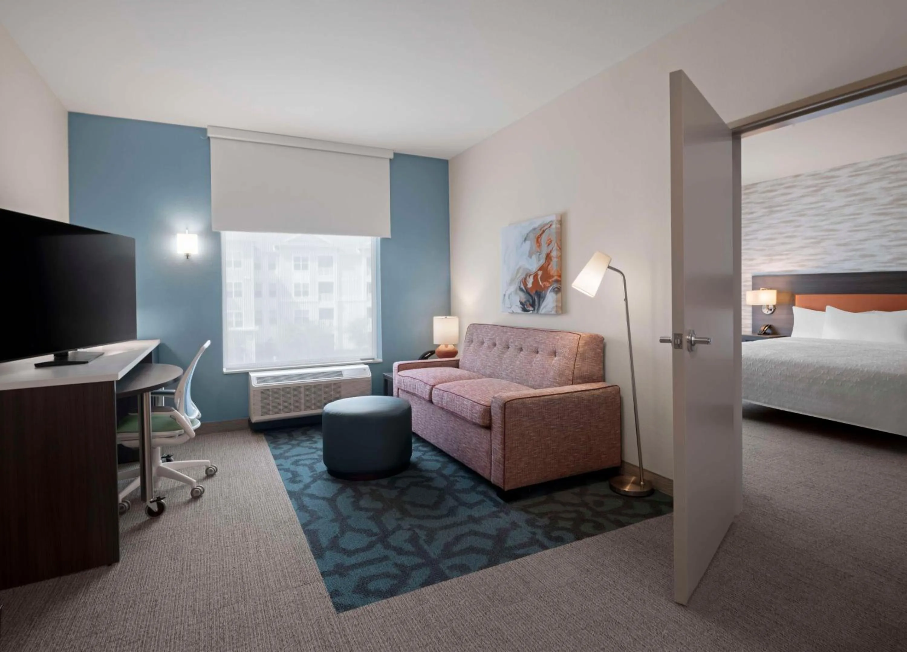 Living room, Bed in Home2 Suites by Hilton Orlando South Davenport