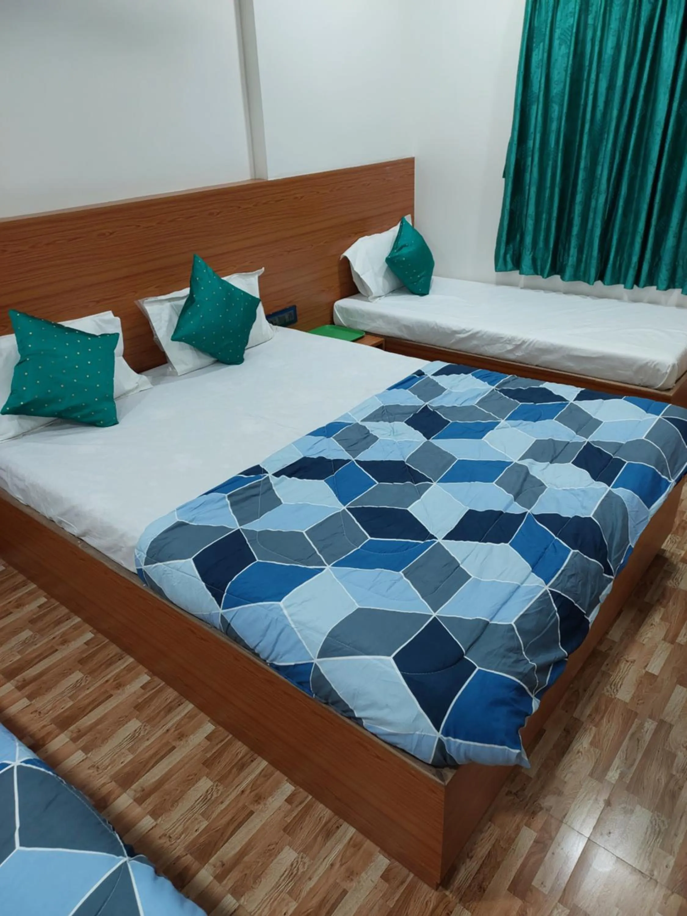 Bed in Hotel Sai Dakshina Inn & The Fern Restaurant