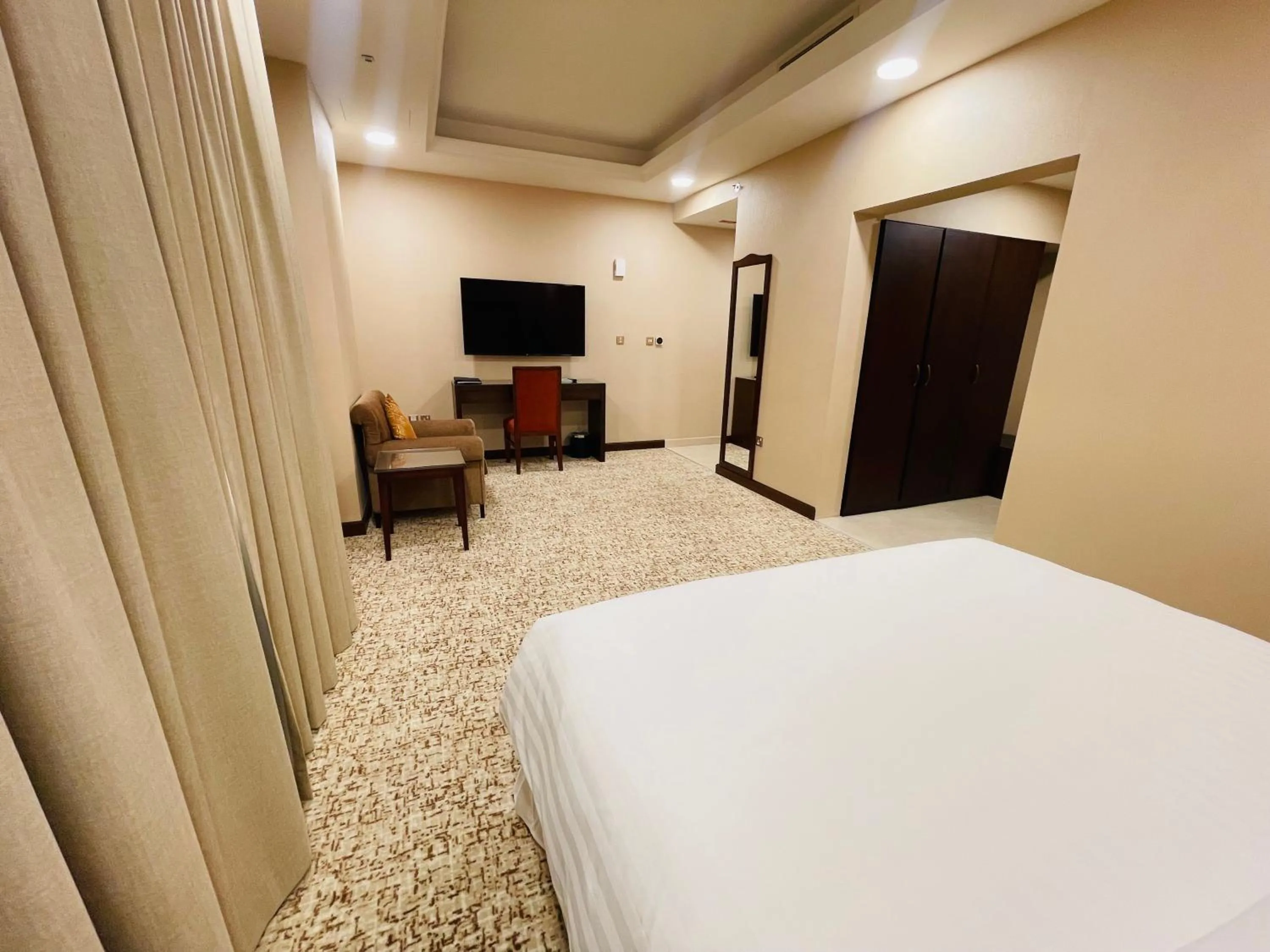 Communal lounge/ TV room, Bed in Grand Legacy Hotel Doha