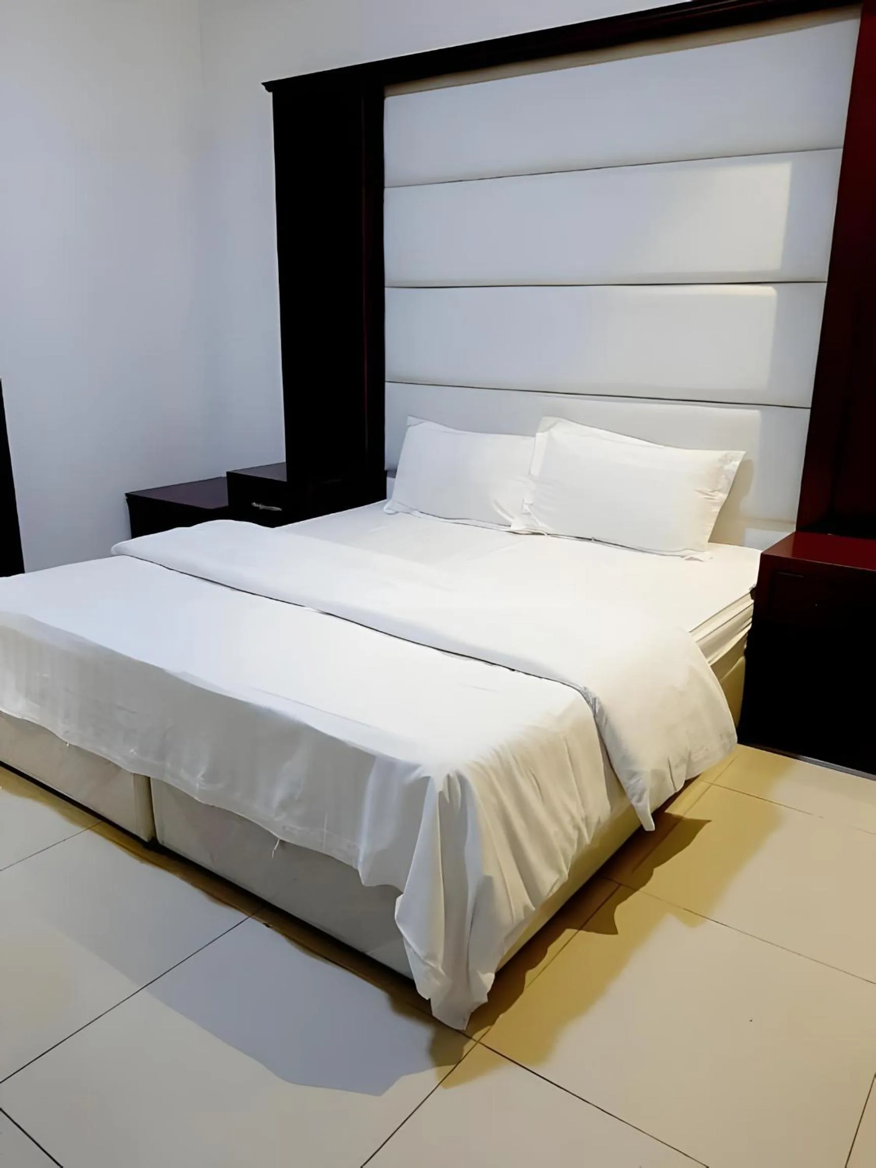 Bed in شقق أهلين ثلاثة للشقق المخدومة