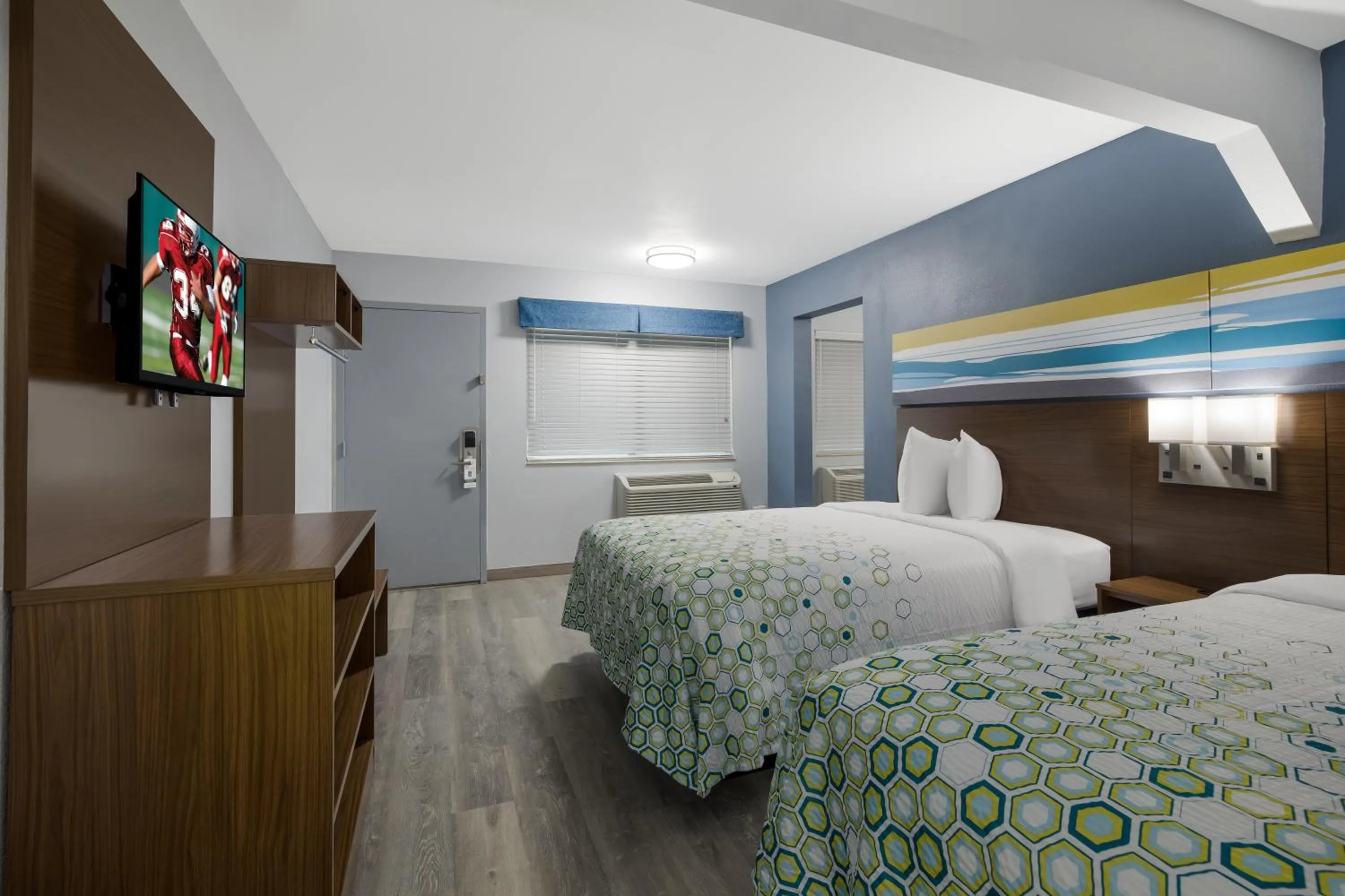 Bed in HomeTowne Studios by Red Roof Orange, TX