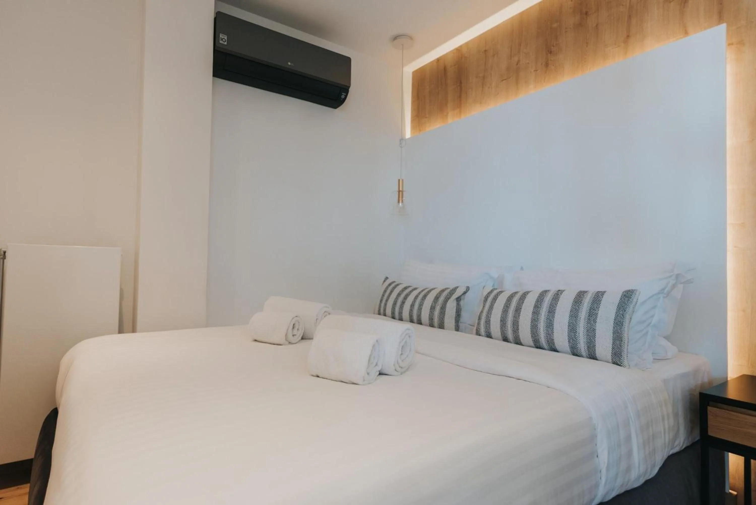 Bed in Earth Boutique Apartments next to Stavros Niarchos