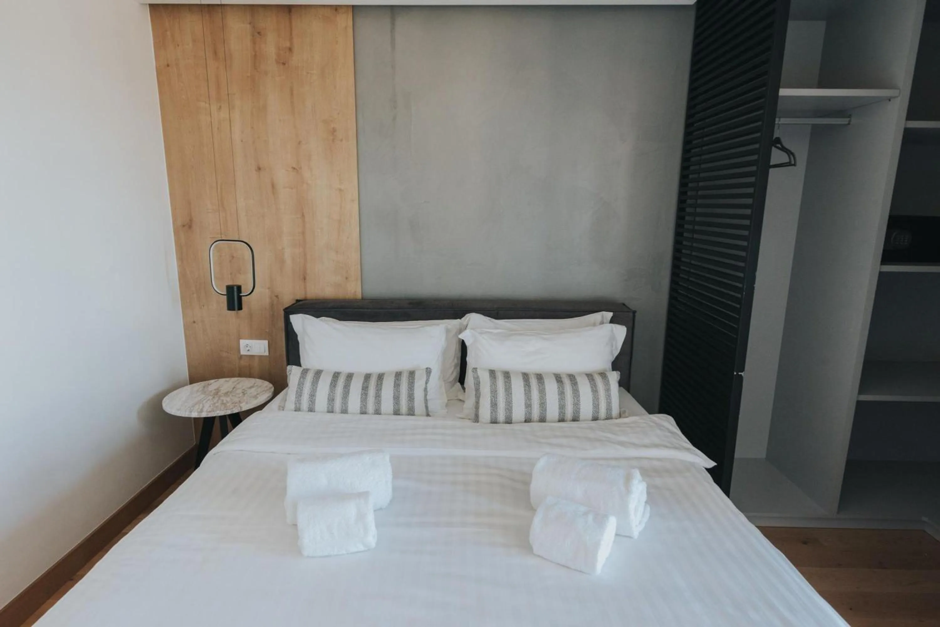 Bed in Earth Boutique Apartments next to Stavros Niarchos