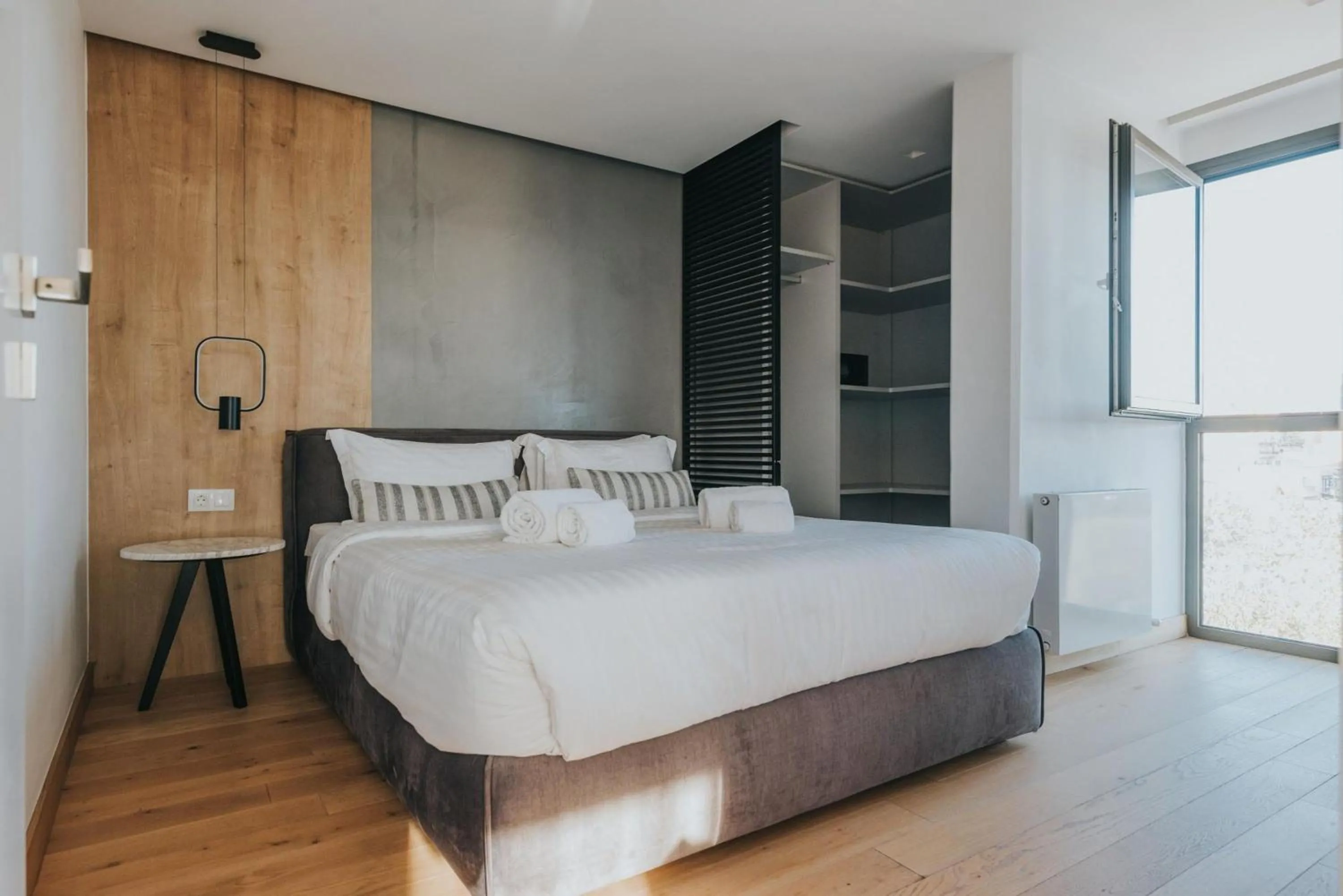 Bed in Earth Boutique Apartments next to Stavros Niarchos